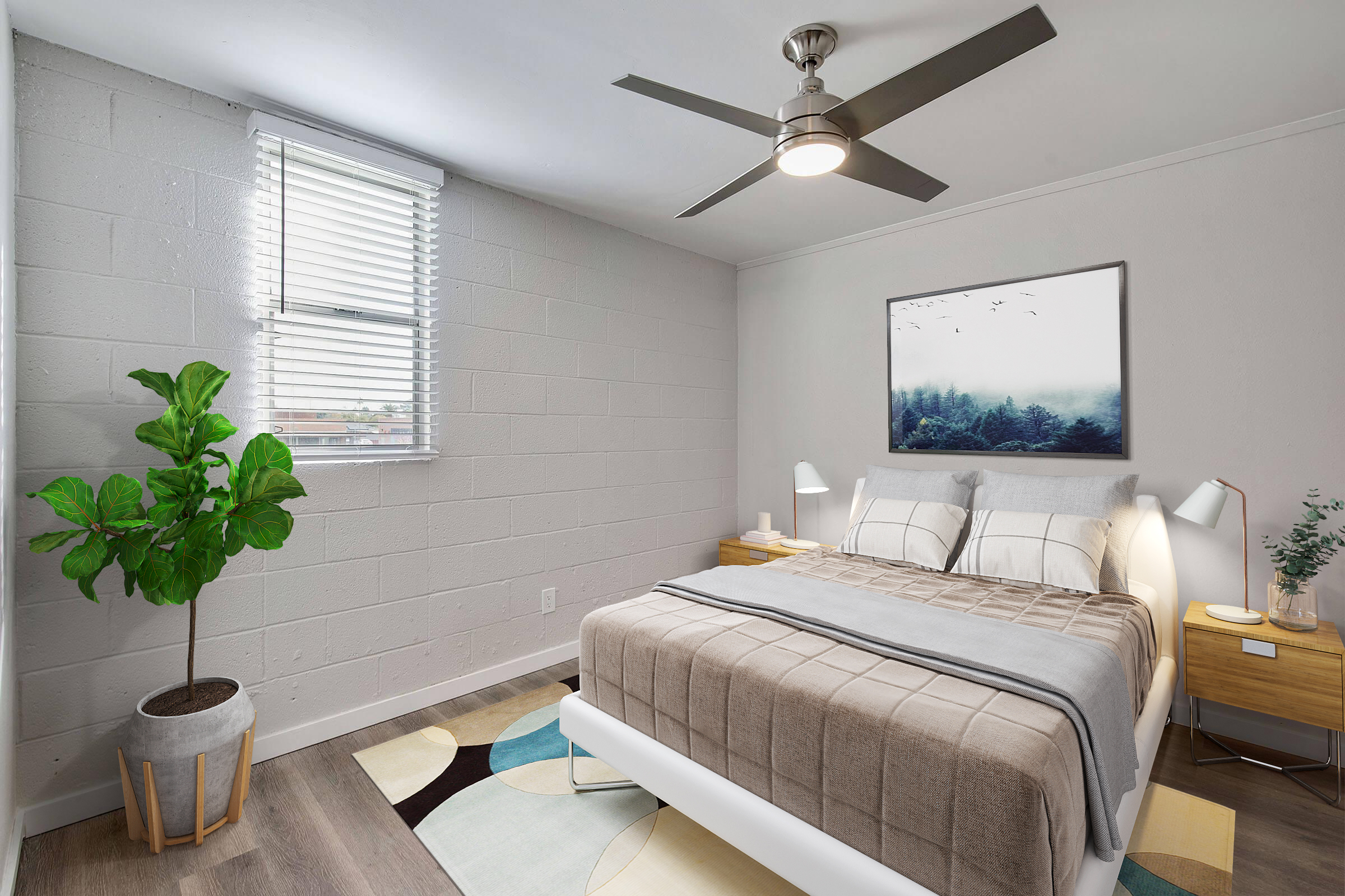 Bright and modern bedroom featuring a white bed with beige bedding, two bedside tables with lamps, a ceiling fan, and a large window with blinds. A potted plant adds a touch of greenery, and a framed landscape picture hangs above the bed, complementing the minimalist decor.