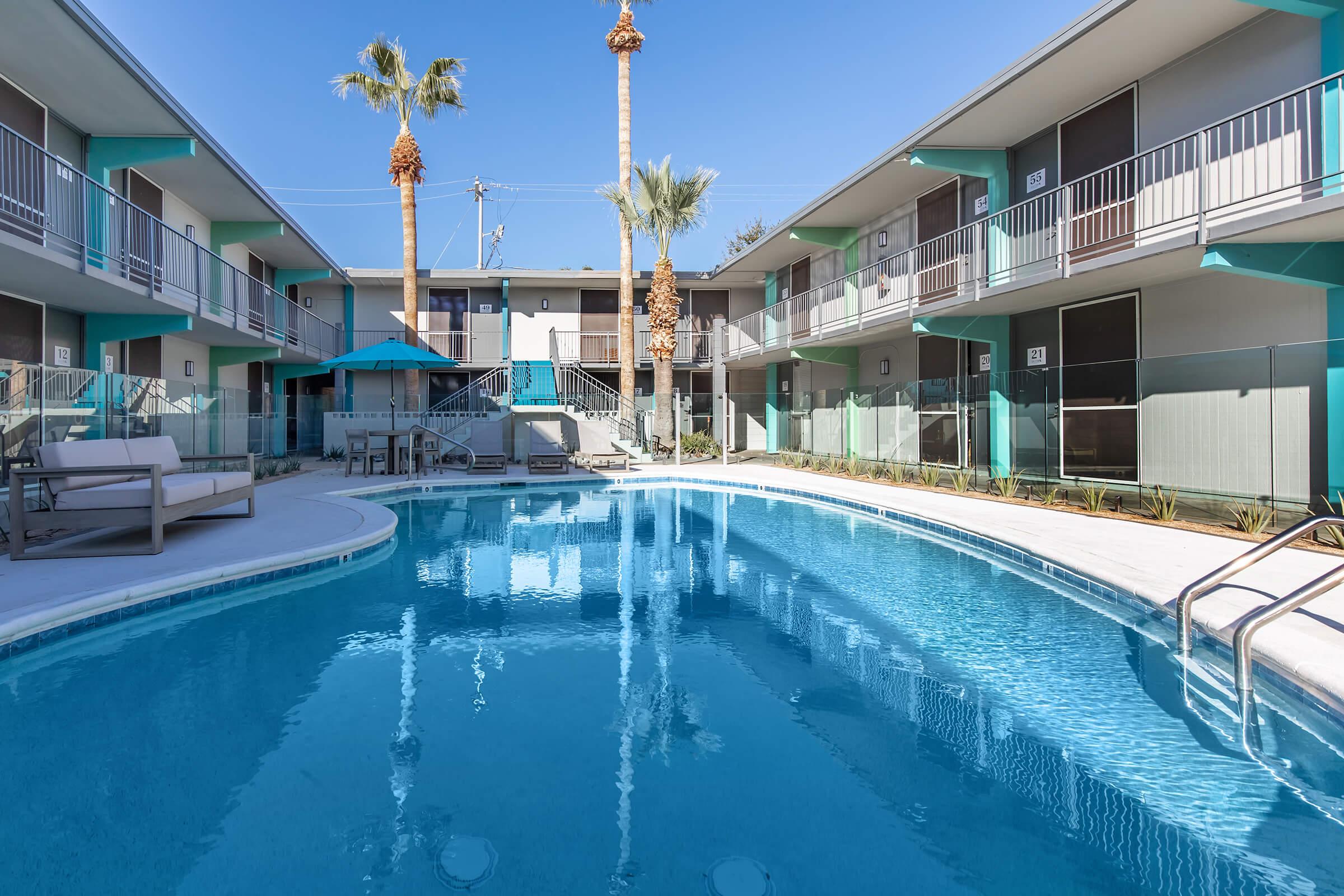 a house with a pool in front of a building