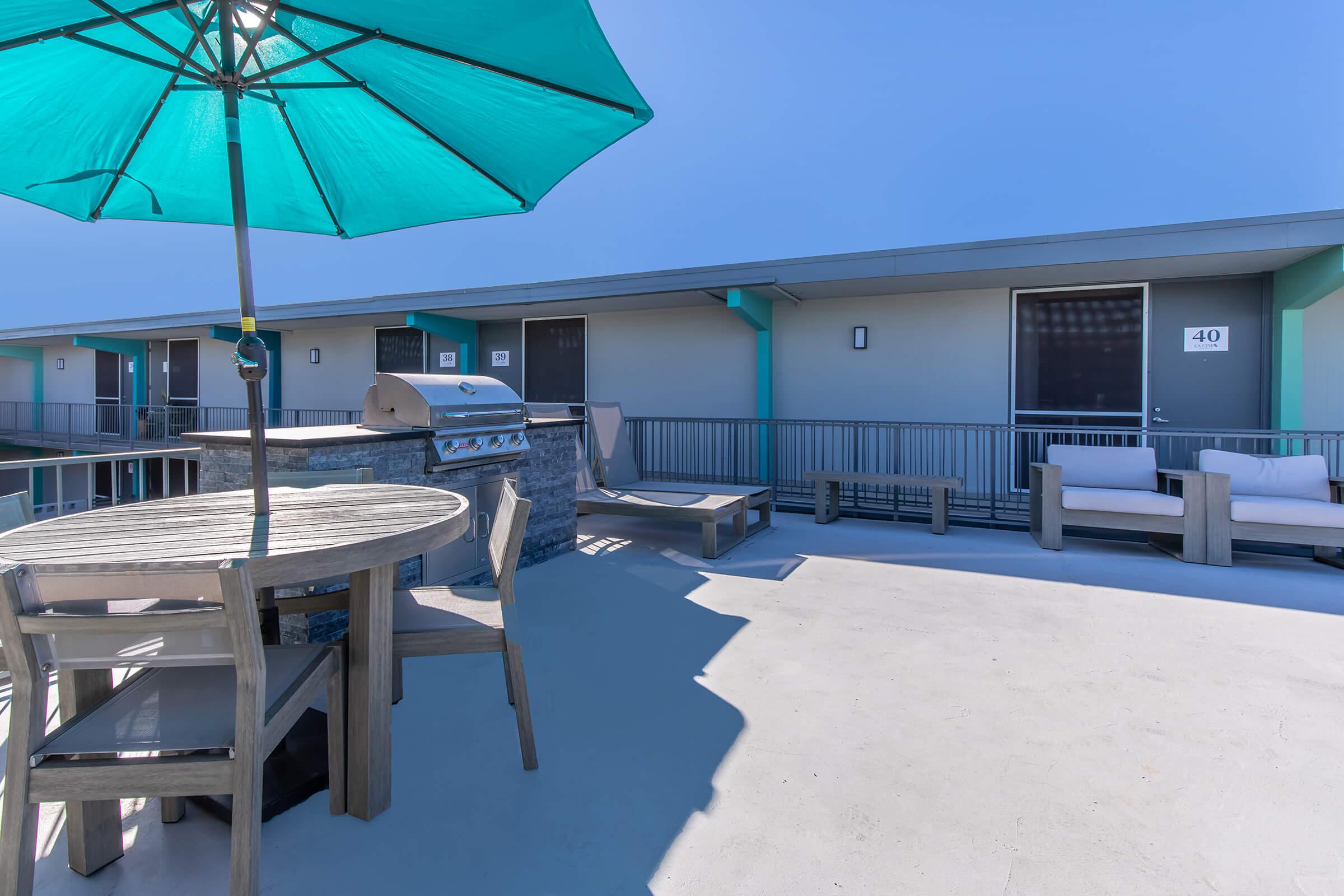 a table topped with a blue umbrella