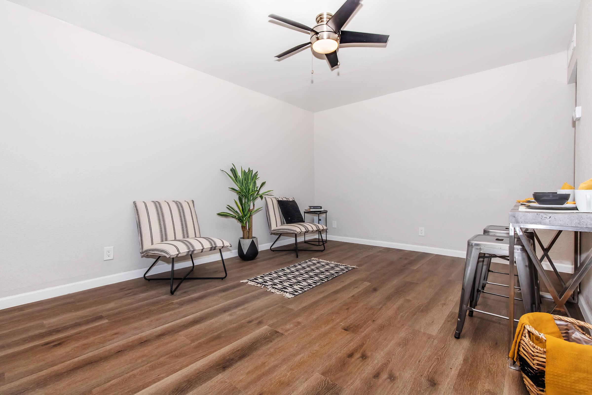 a bedroom with a desk and chair in a room