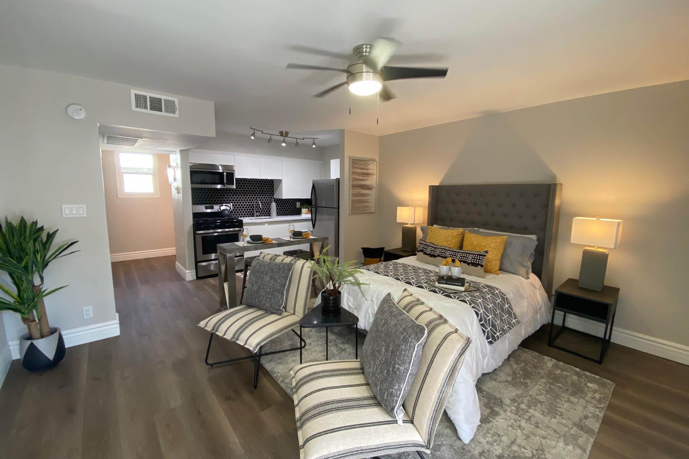 a living room filled with furniture and a bed