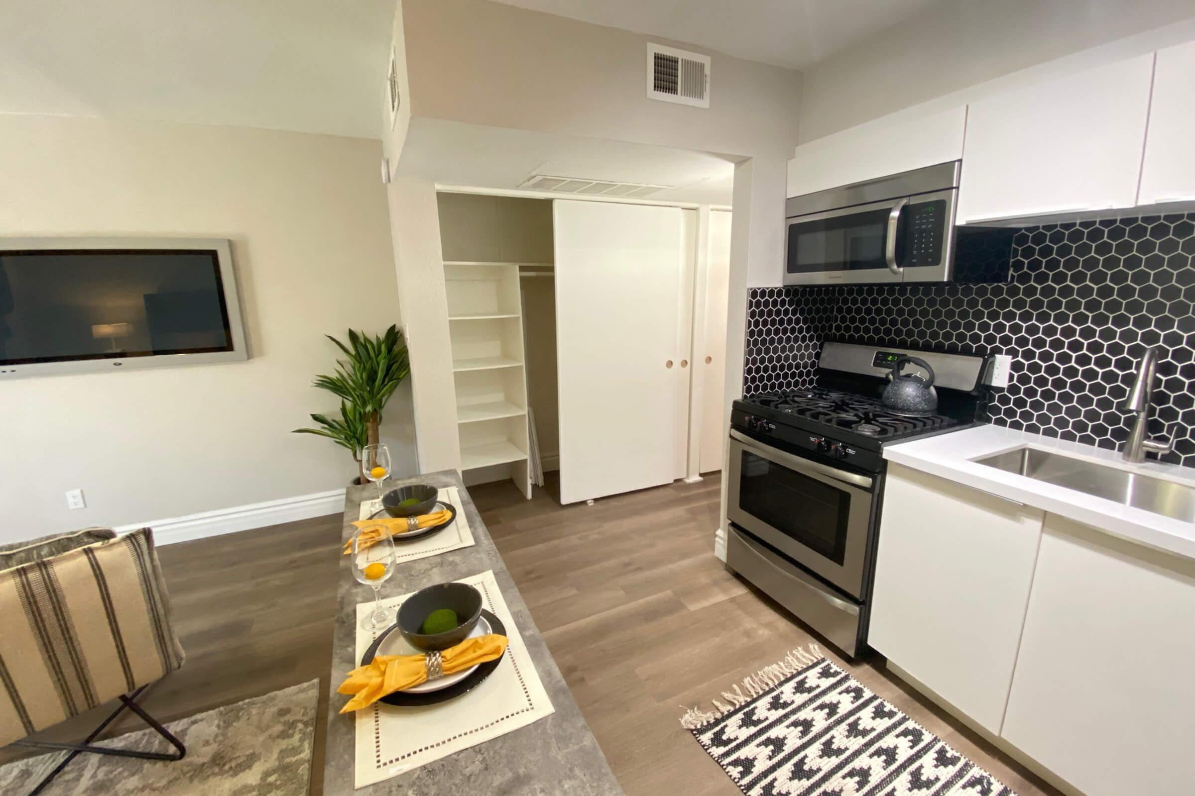 a kitchen with a stove top oven sitting inside of a room