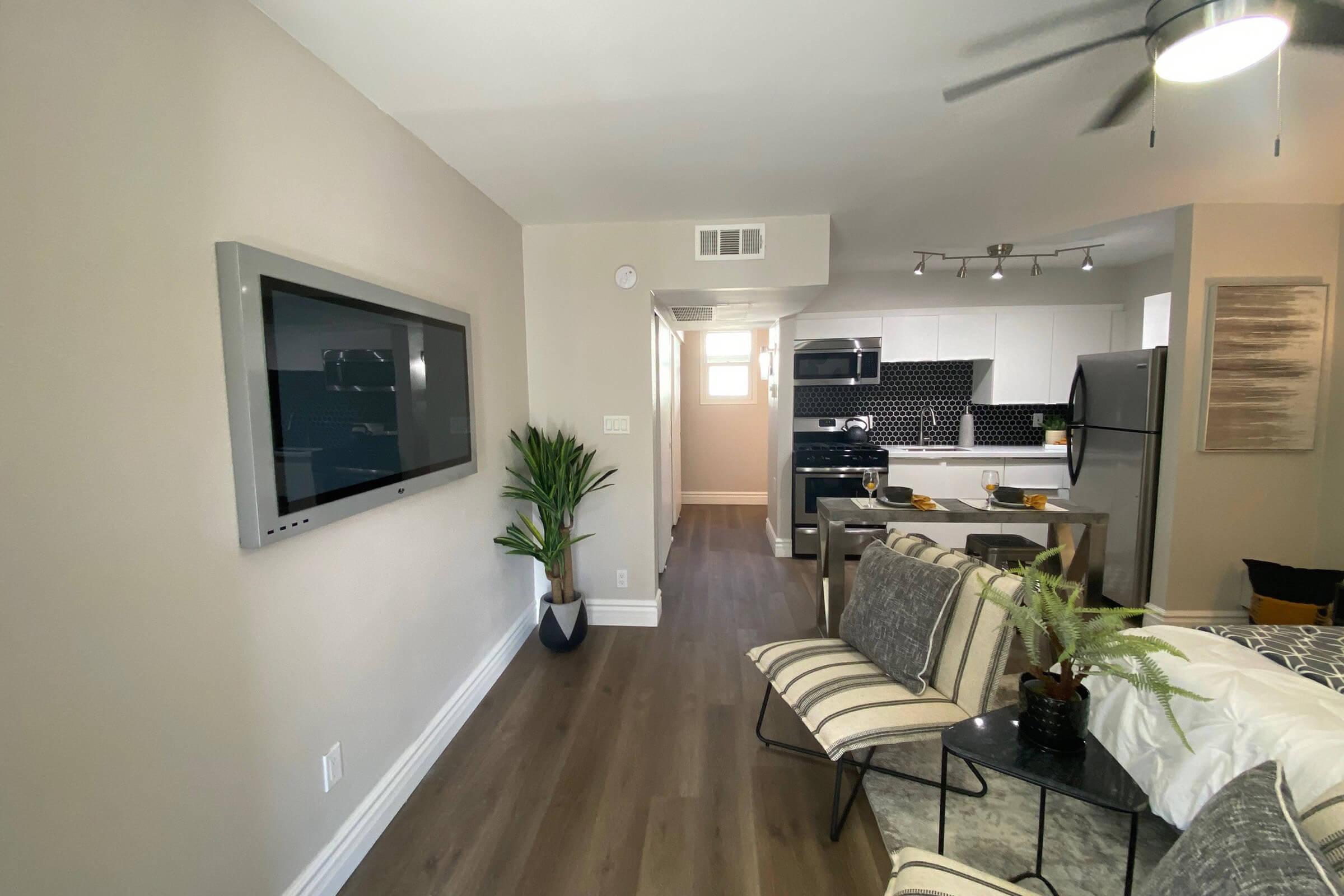 a living room filled with furniture and a flat screen tv