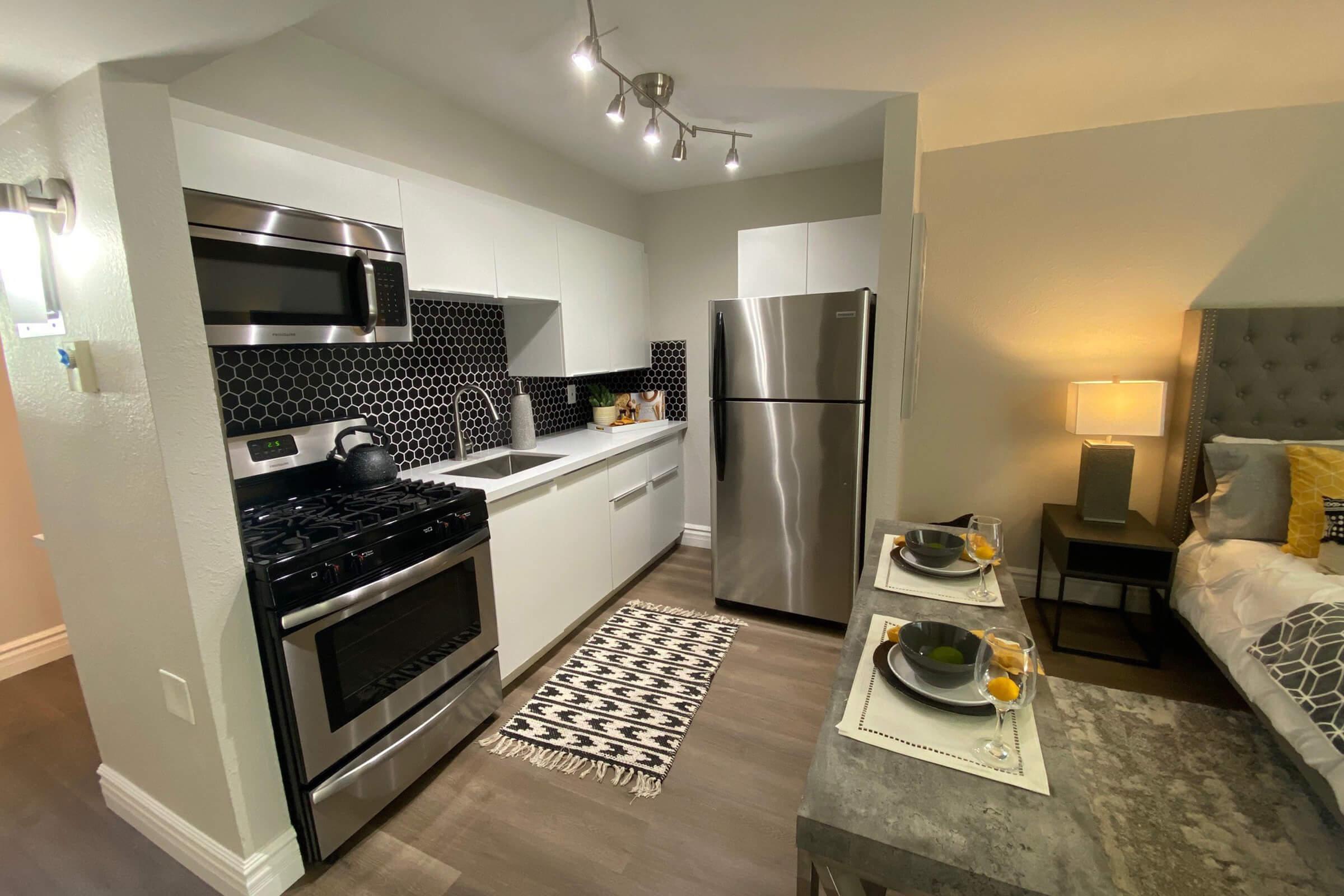 a stove top oven sitting inside of a kitchen