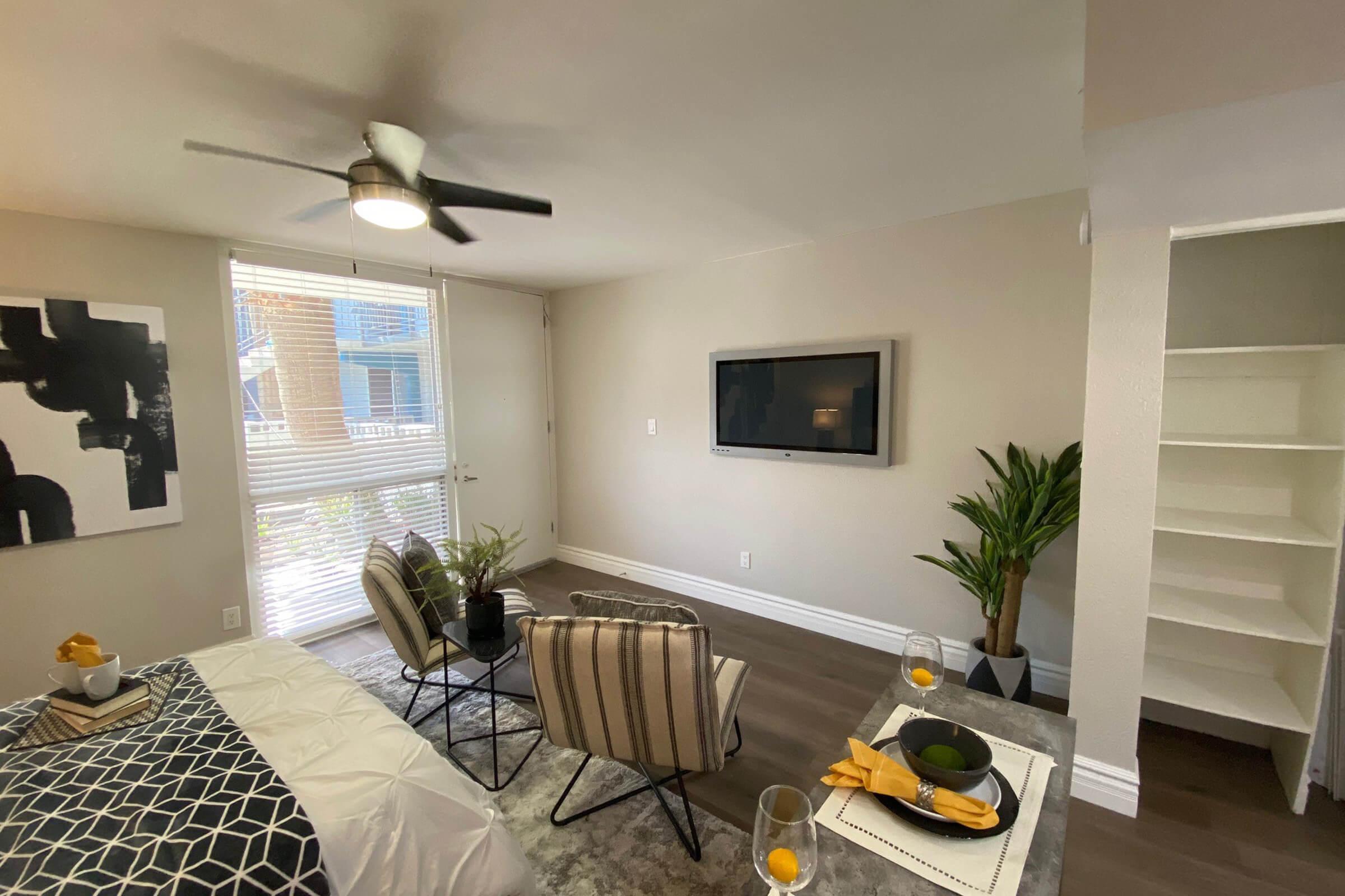 a living room filled with furniture and a large window