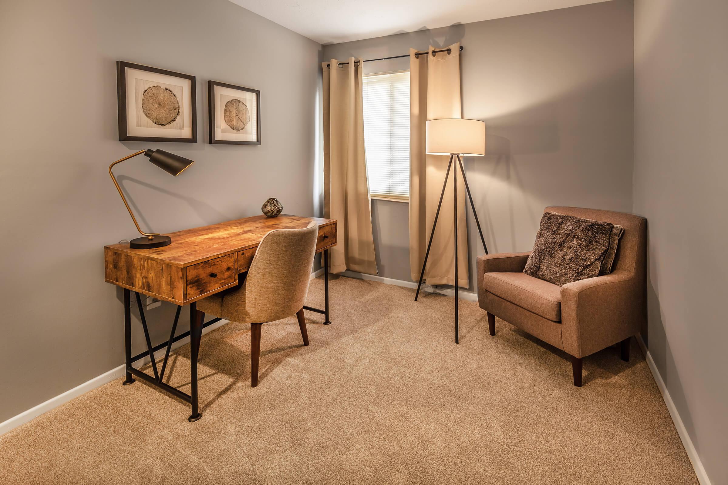 a living room filled with furniture and a large window