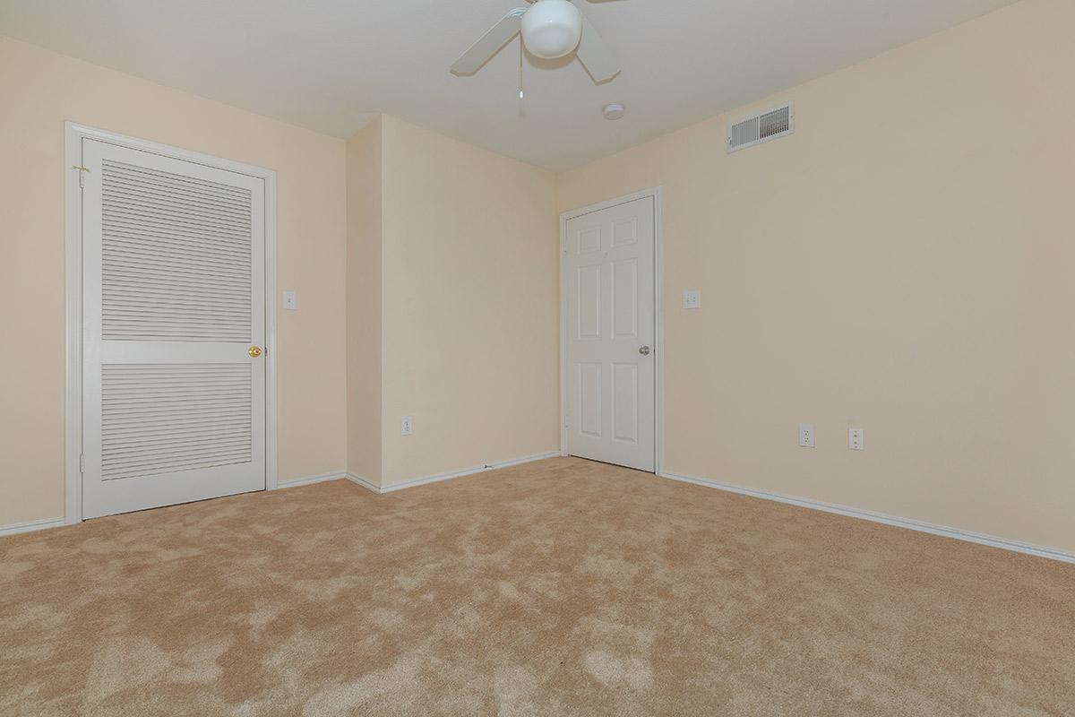 a bedroom with a bed in a room