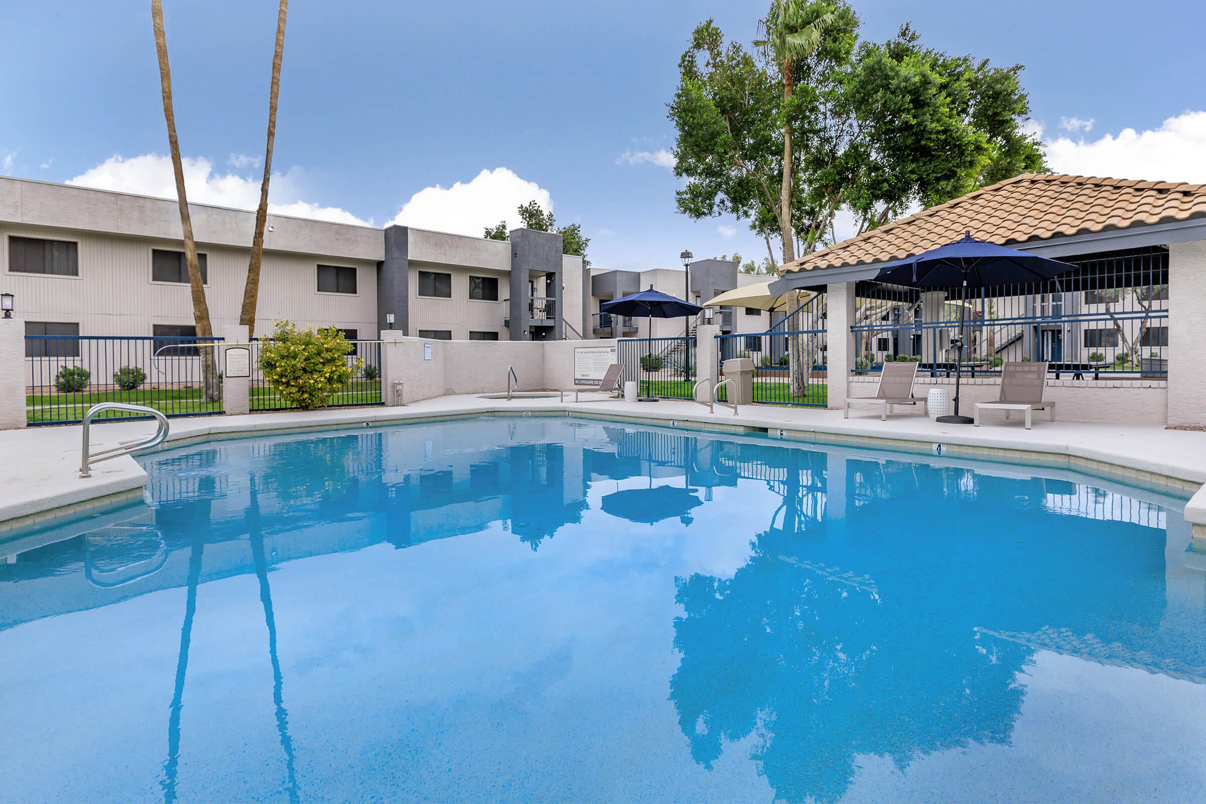 a house with a pool in front of a building