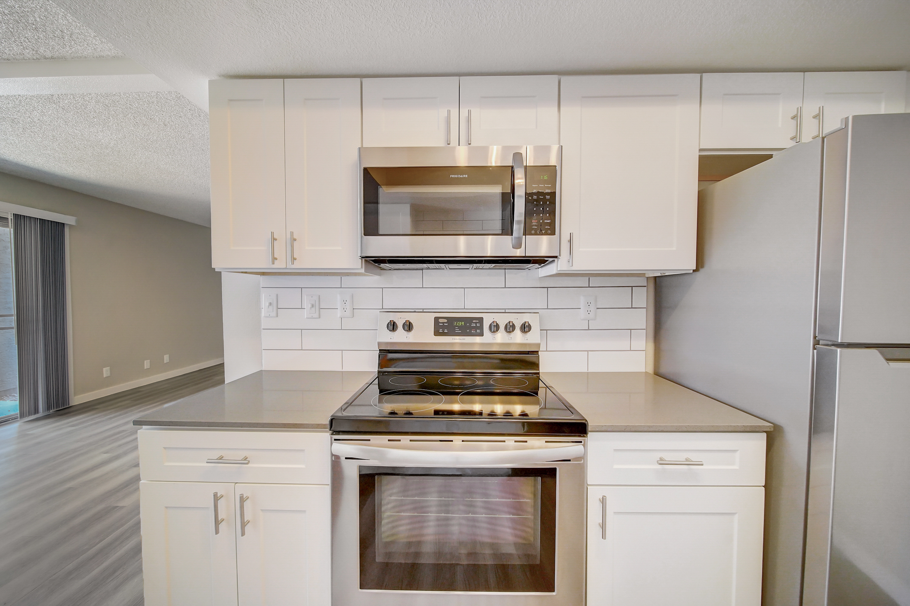 a stove top oven sitting inside of a kitchen