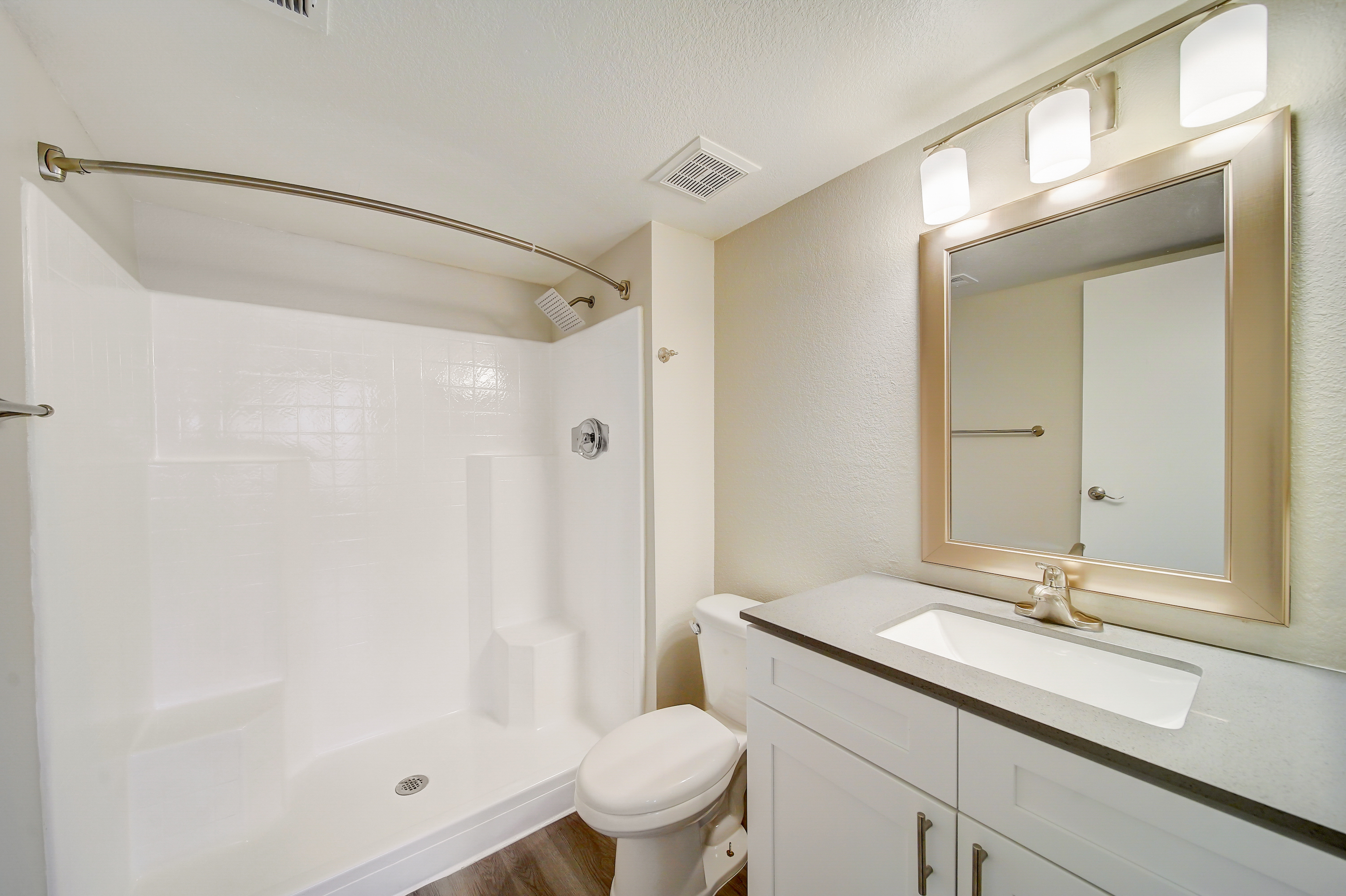 a shower that has a sink and a mirror