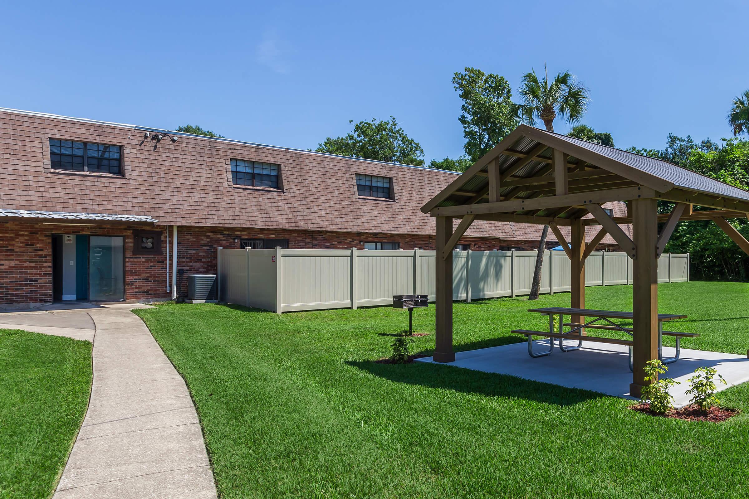 a large lawn in front of a brick building