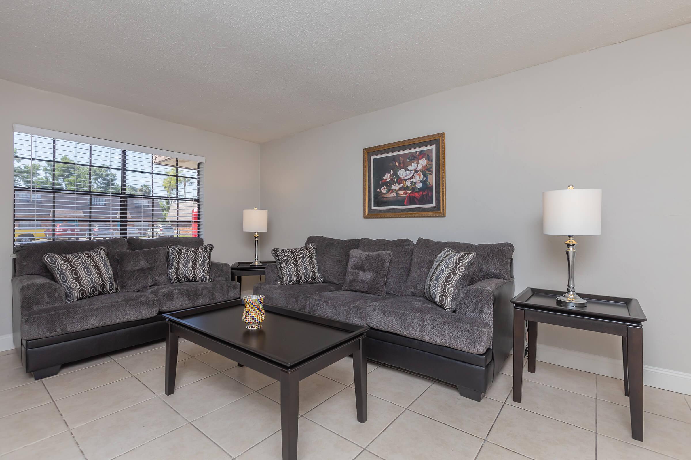 a living room filled with furniture and a large window