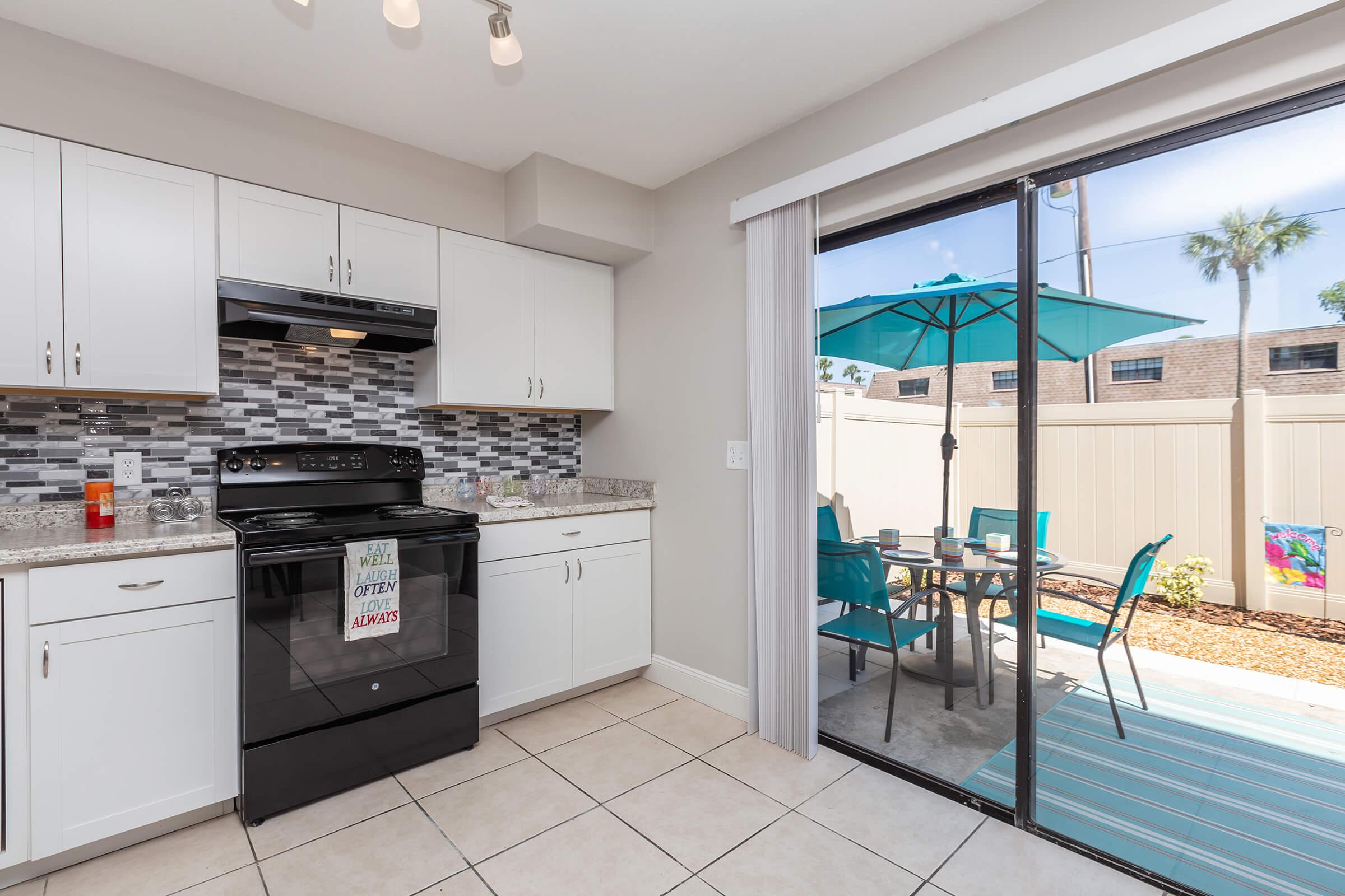 a kitchen with a stove top oven sitting inside of a building