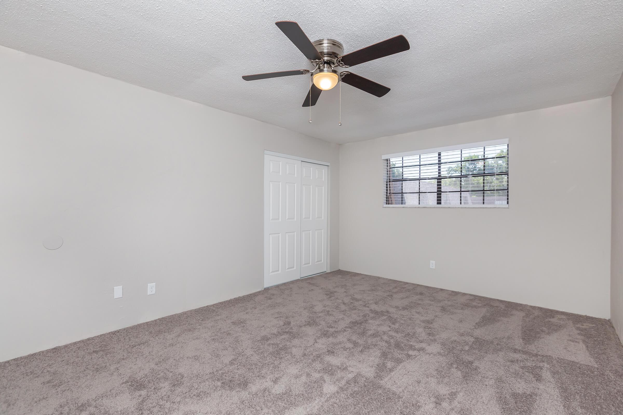 a room that has a clock at the top of a bed