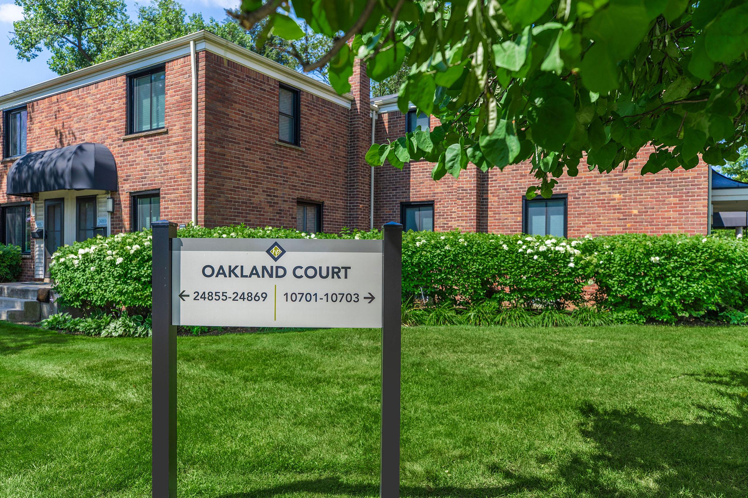 a sign in front of a brick building