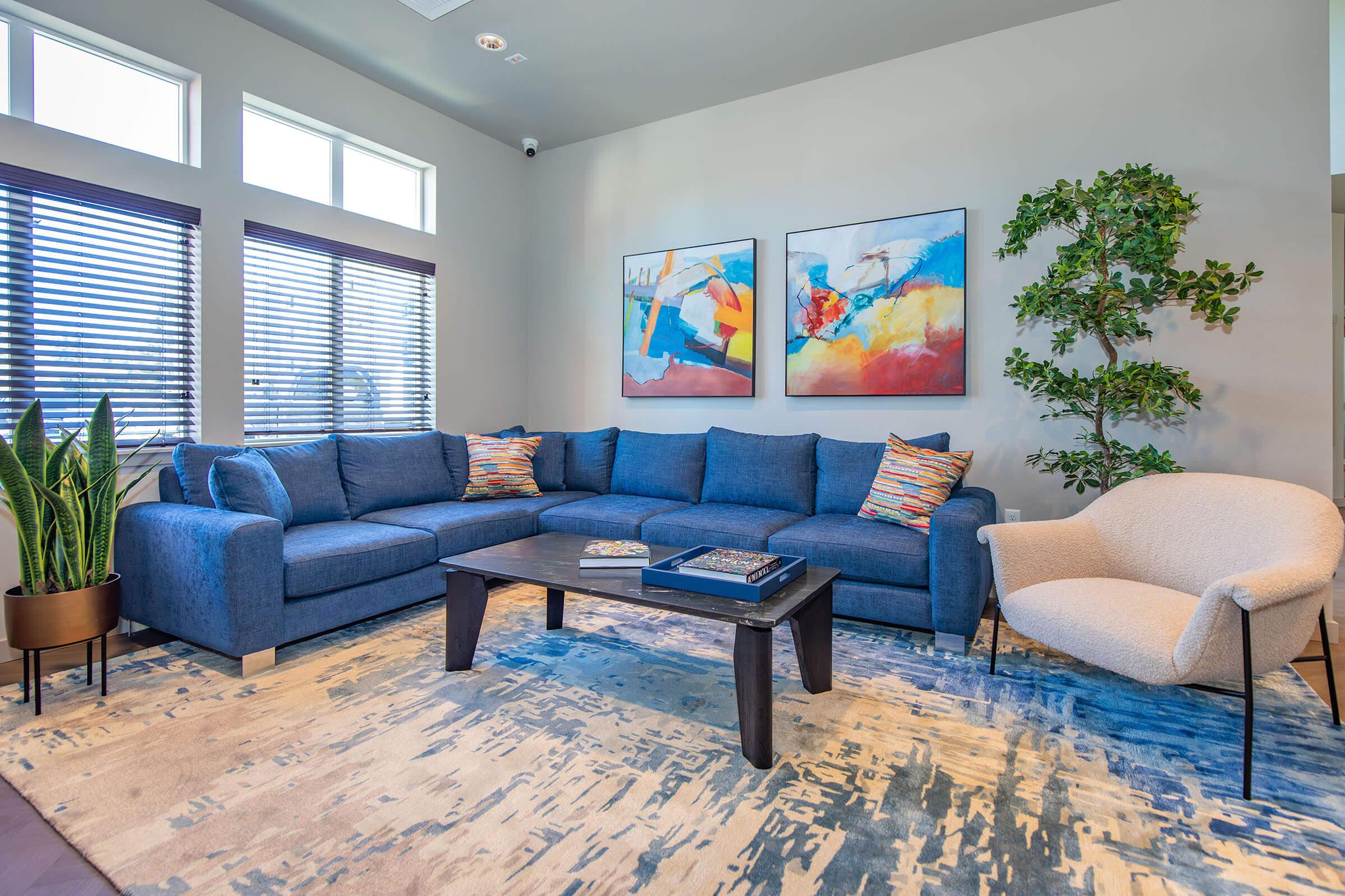 a living room filled with furniture and a large window