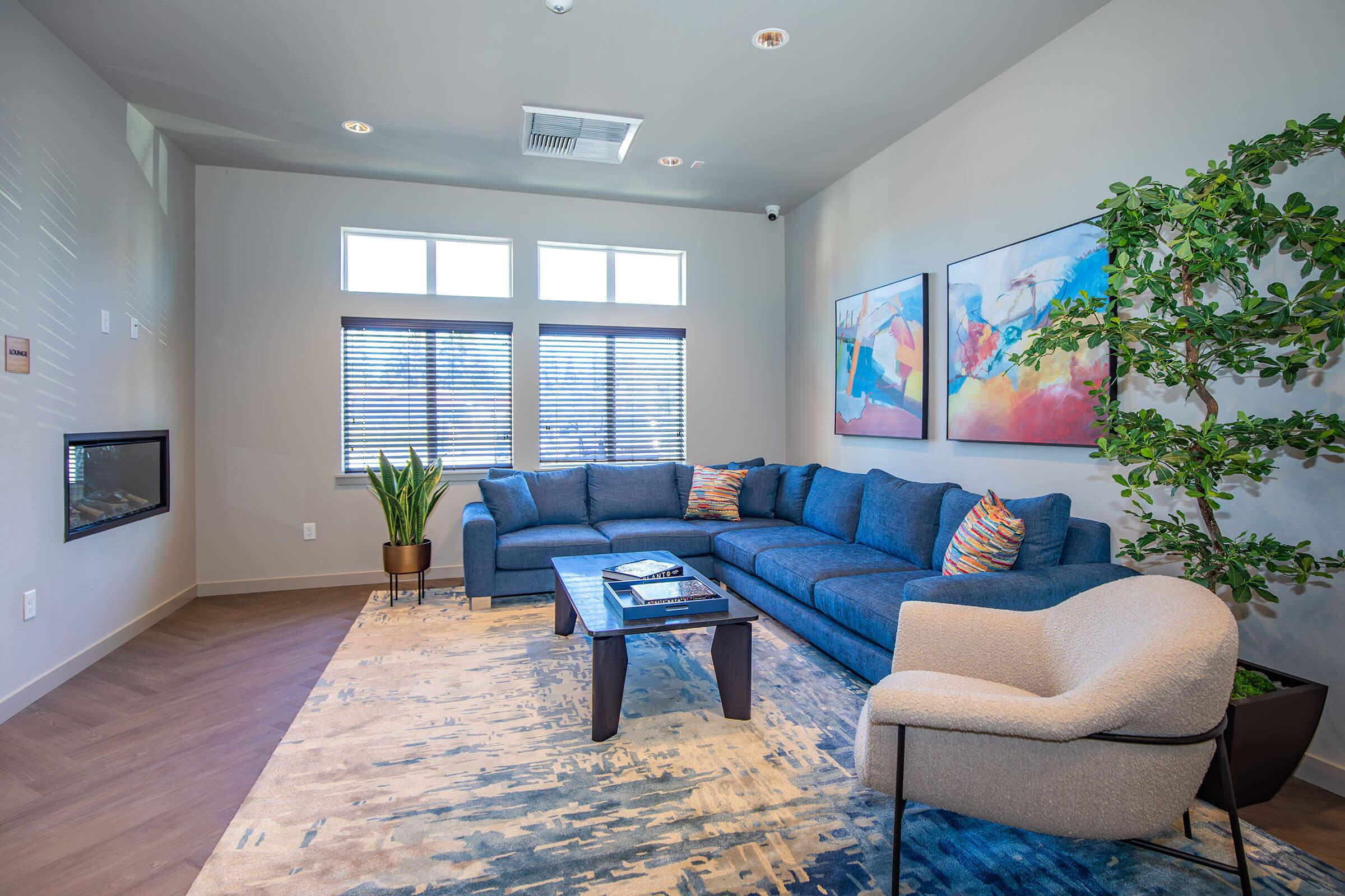 a living room filled with furniture and a large window