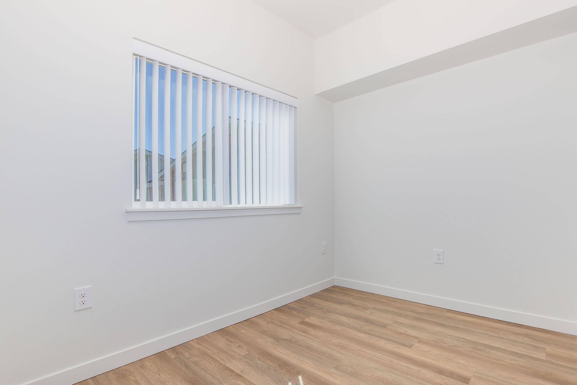 a bedroom with a large window