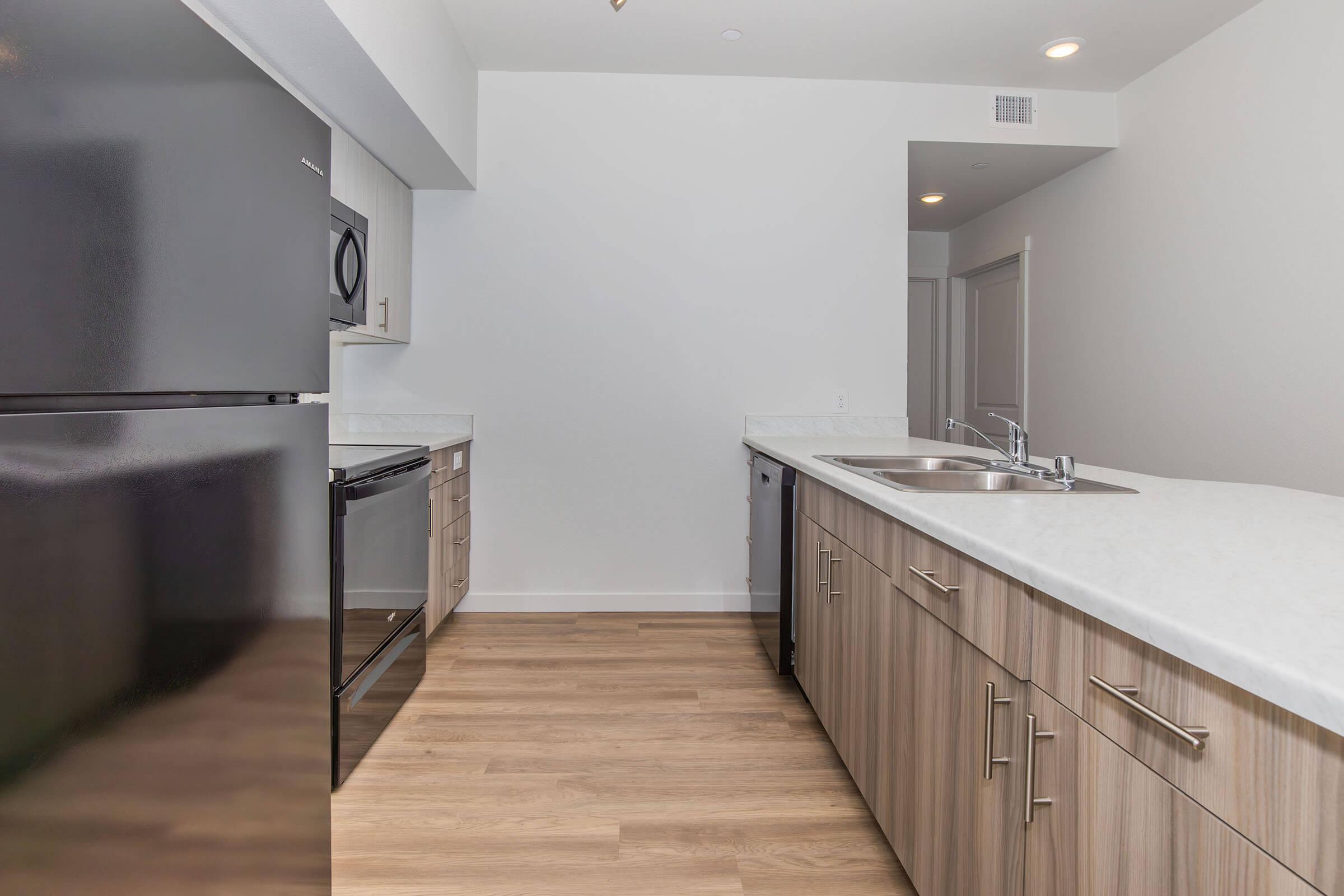 a kitchen with a sink and a refrigerator