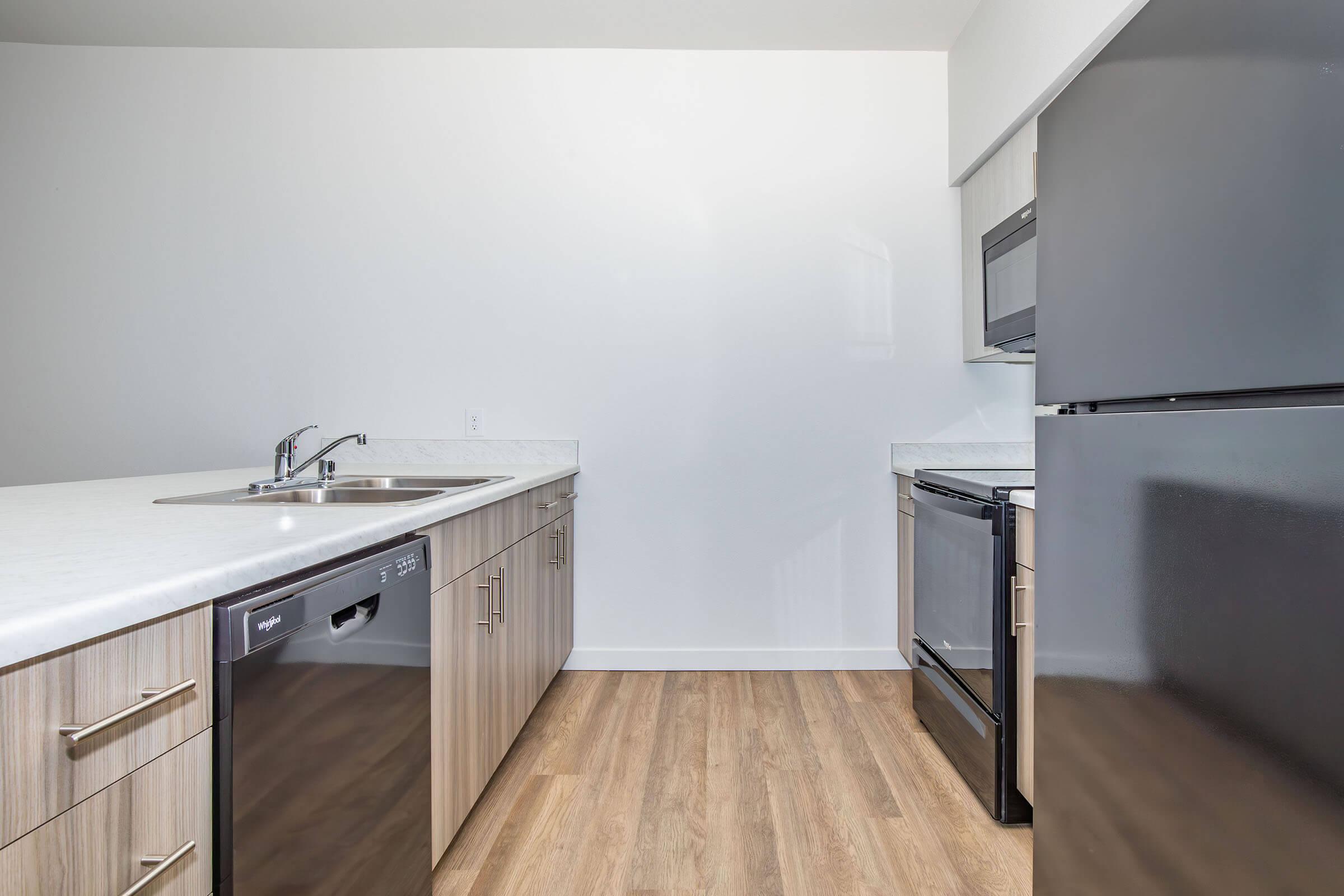 a kitchen with a sink and a refrigerator