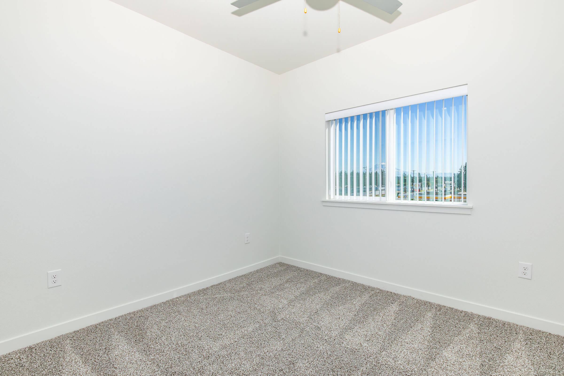 a bedroom with a large window