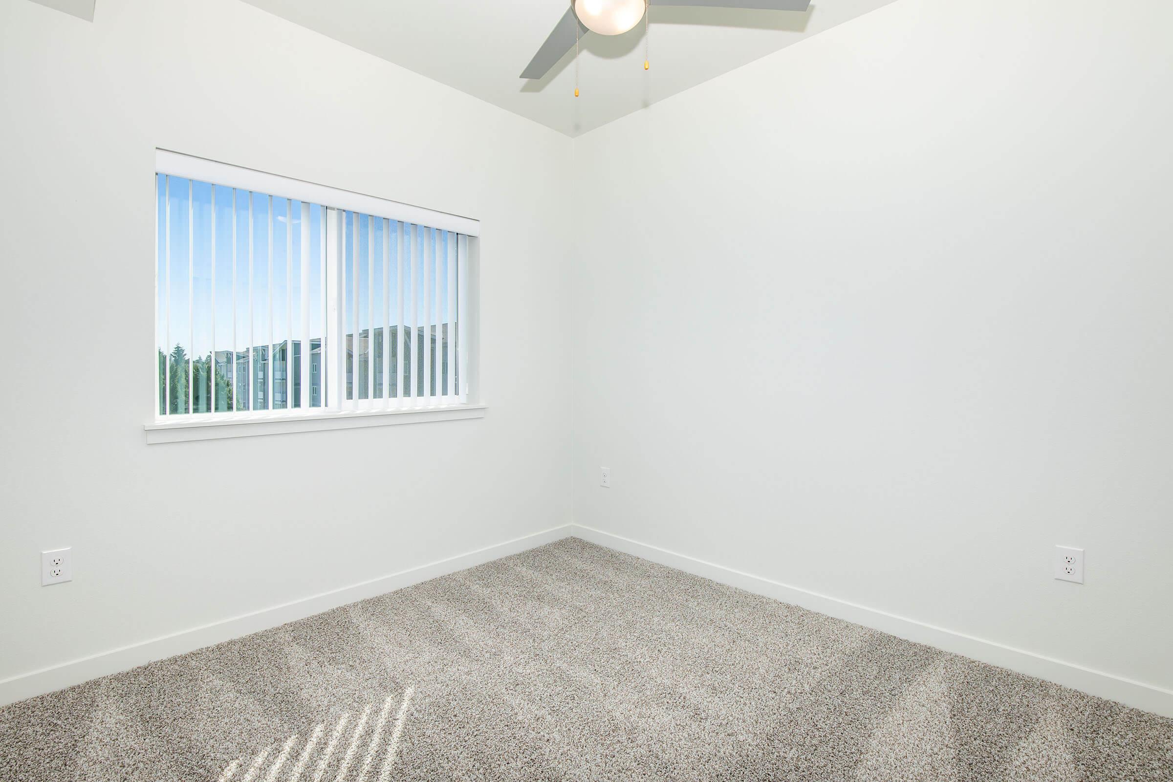 a bedroom with a large window