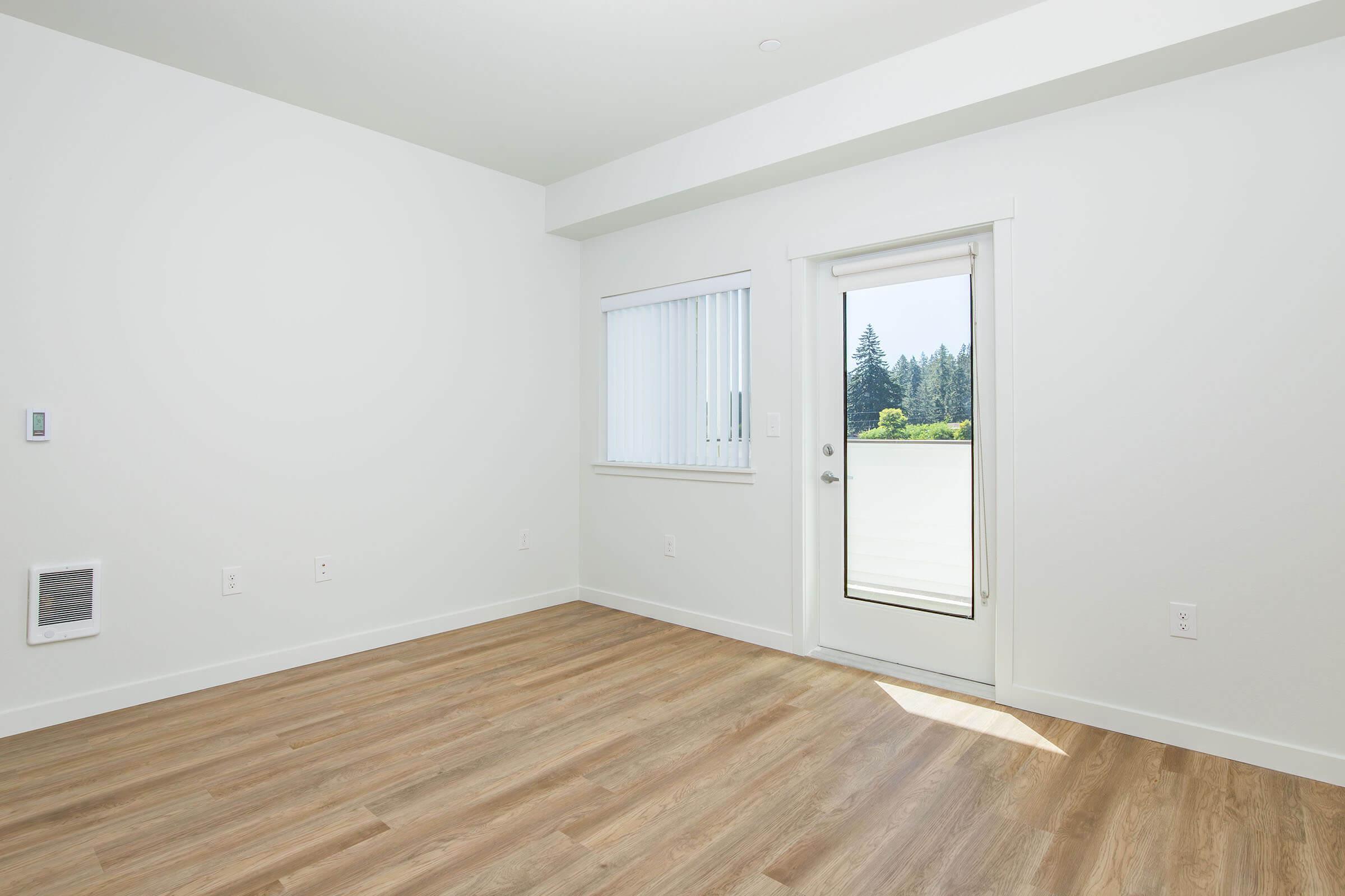 a large empty room with a wooden floor