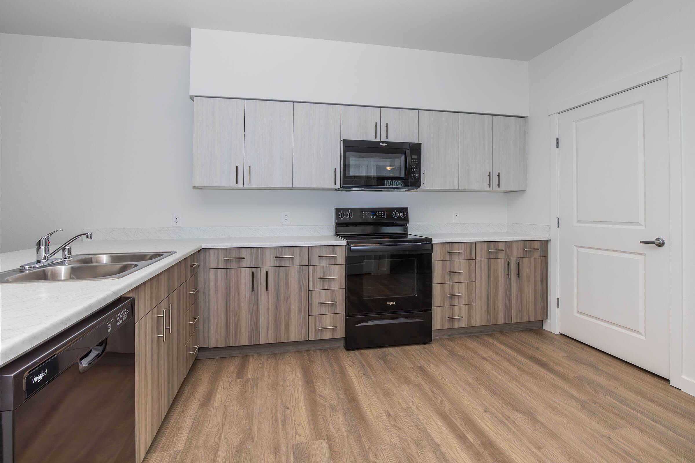 a kitchen with stainless steel appliances and wooden cabinets