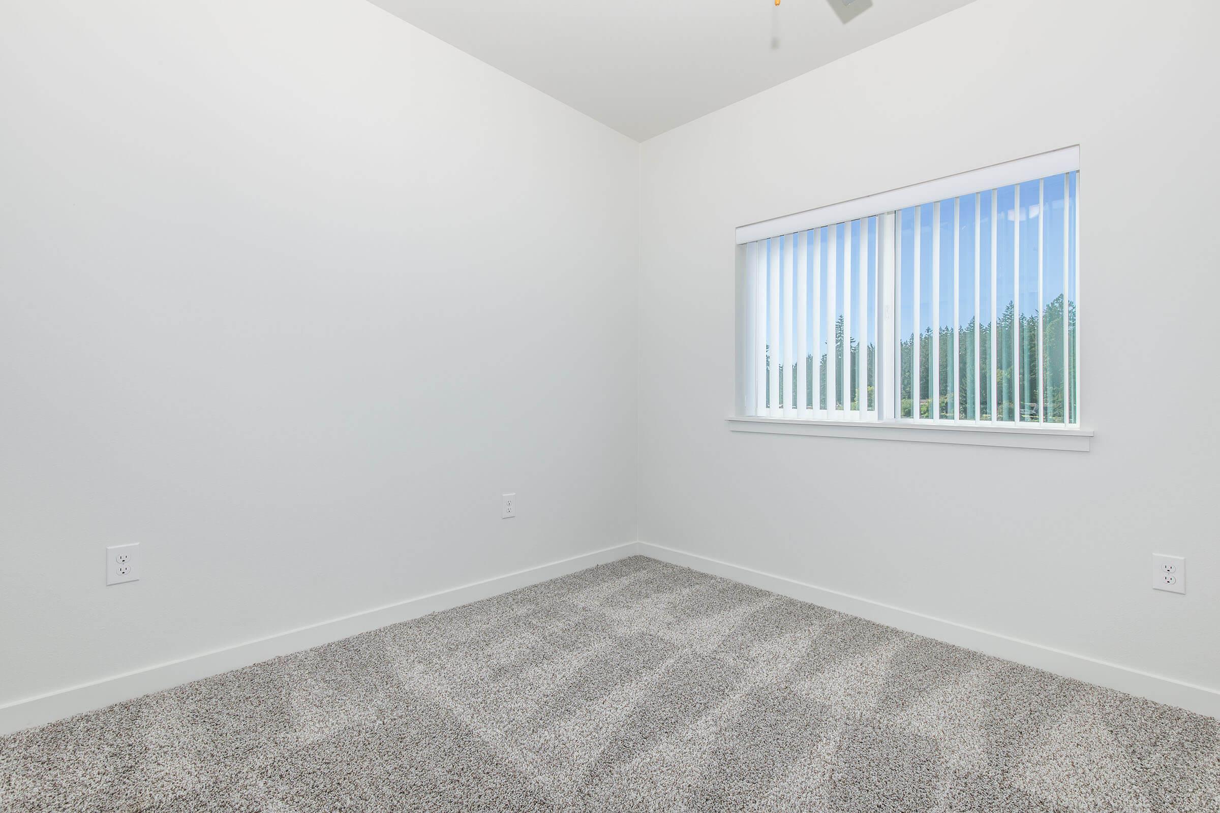 a bedroom with a large window