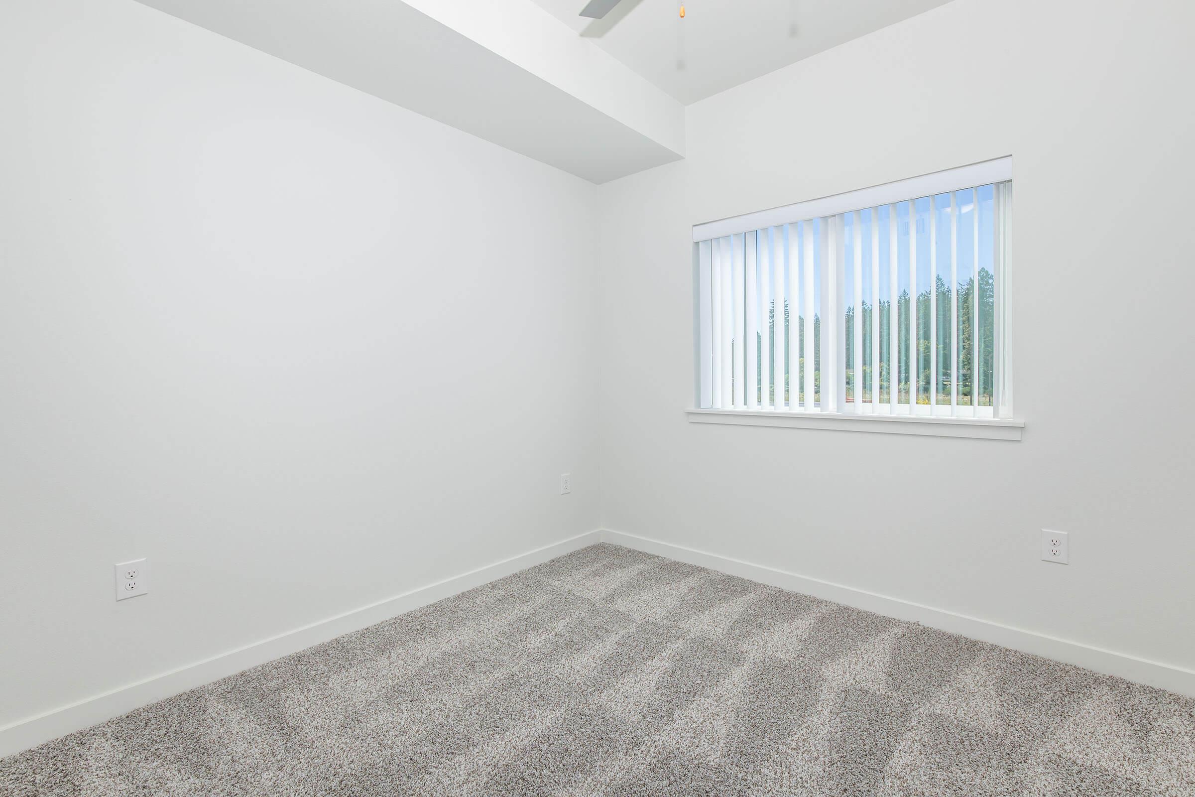 a bedroom with a large window