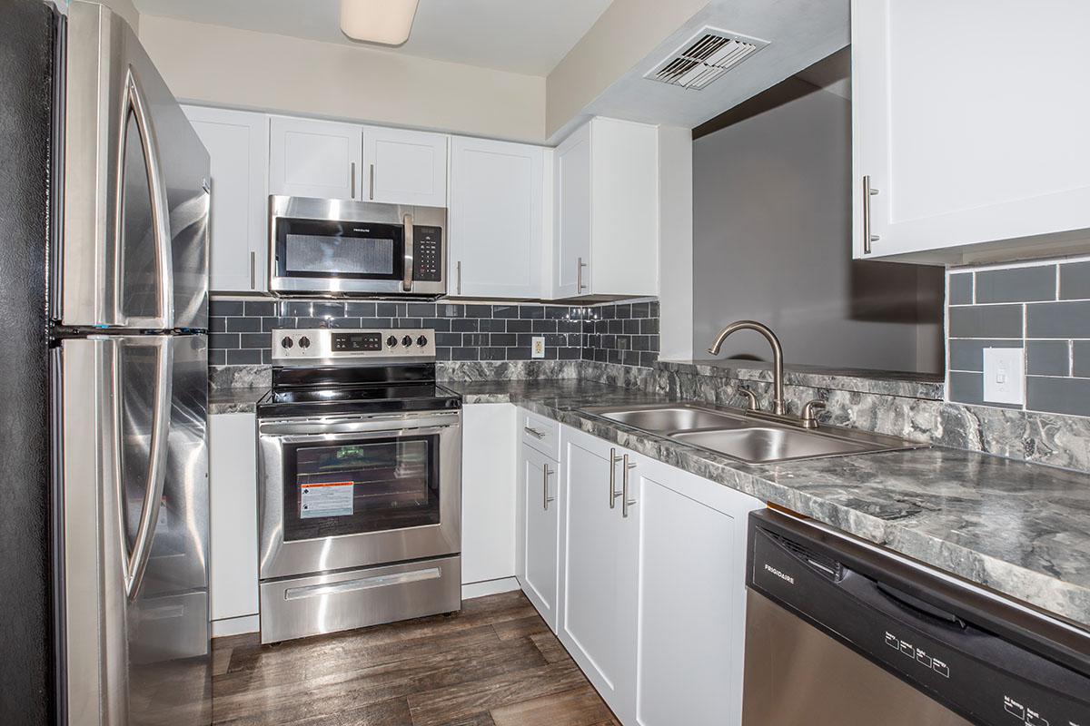 a large kitchen with stainless steel appliances