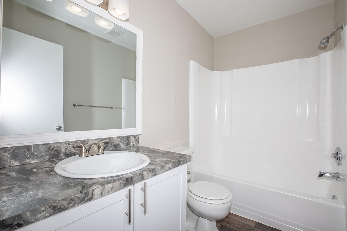 a large white tub next to a sink