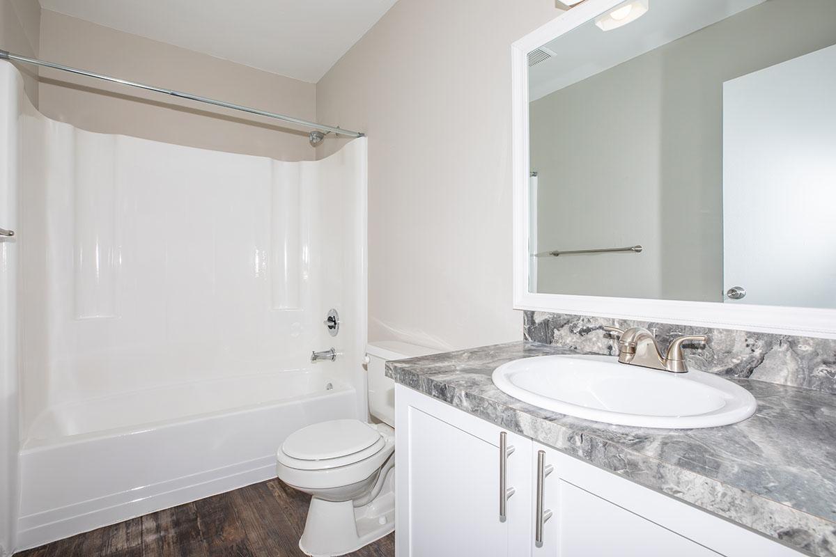 a large white tub next to a sink