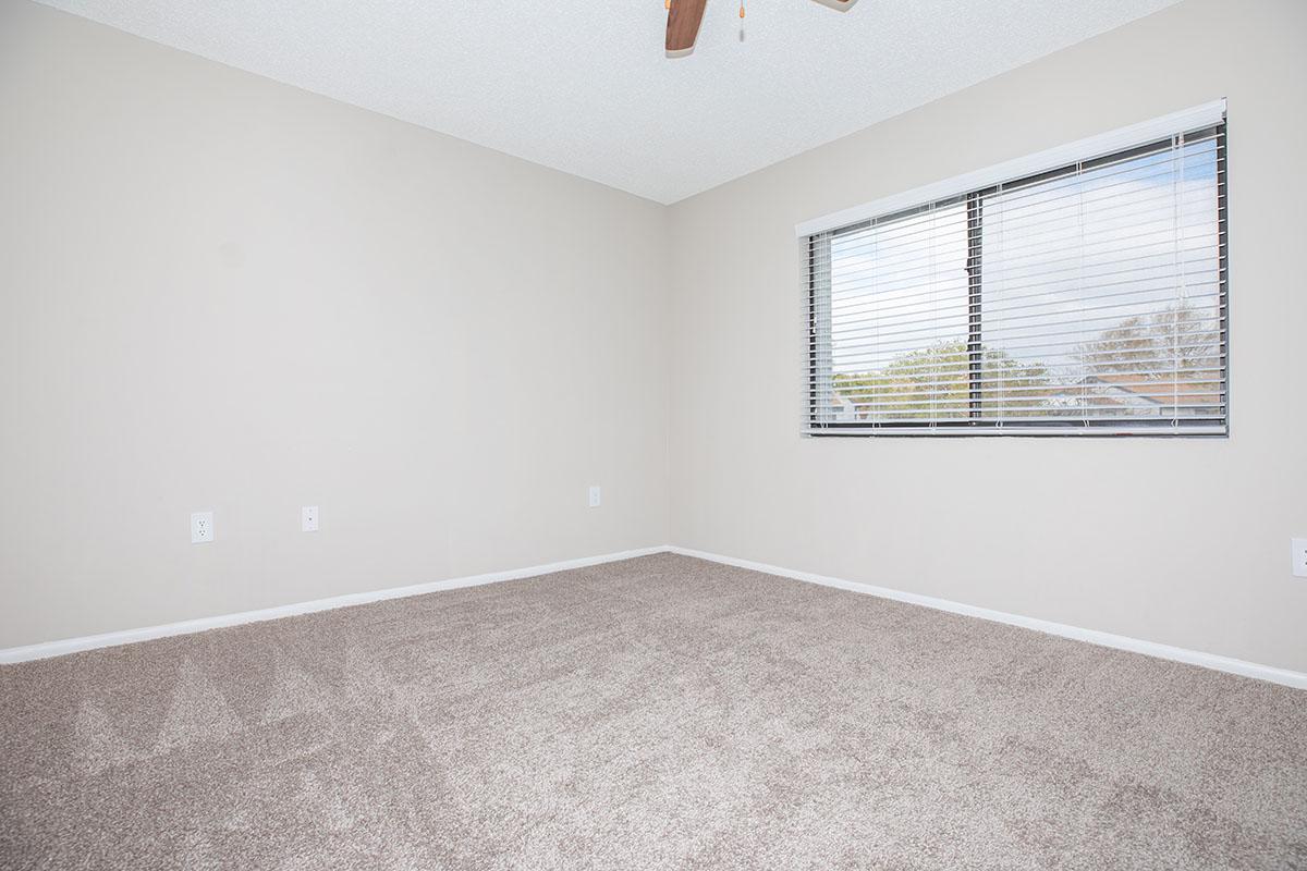a bedroom with a bed and a mirror