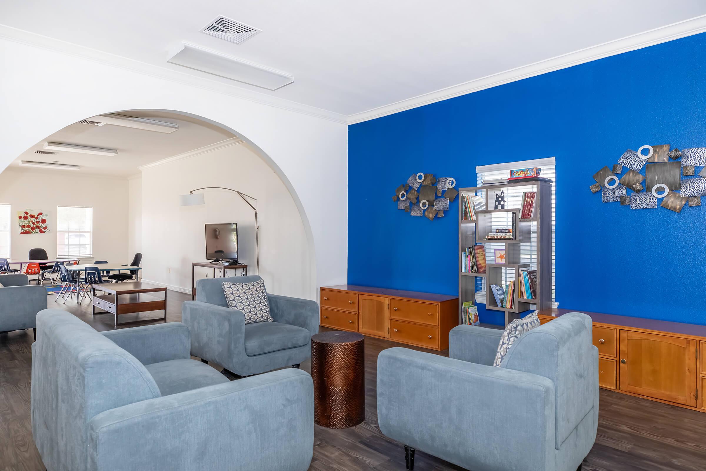 a living room filled with furniture and a blue sky