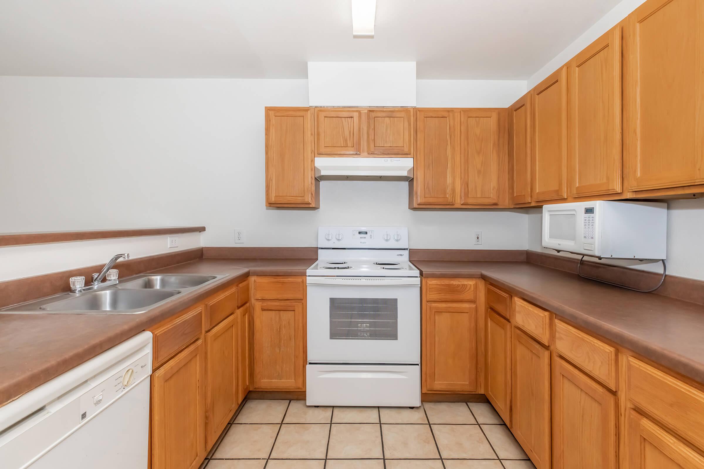 a kitchen with a stove sink and refrigerator