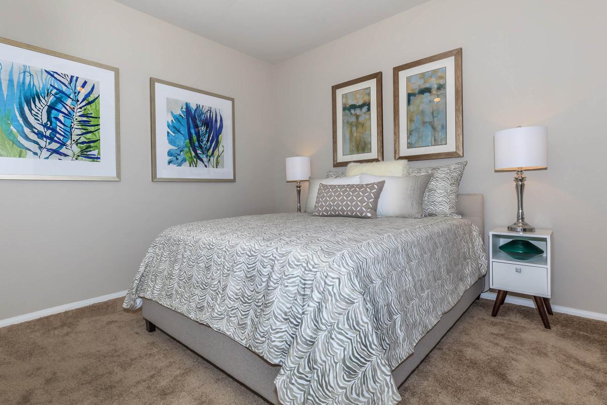 COMFORTABLE BEDROOM AT THE SUMMIT AT SUNRIDGE APARTMENTS