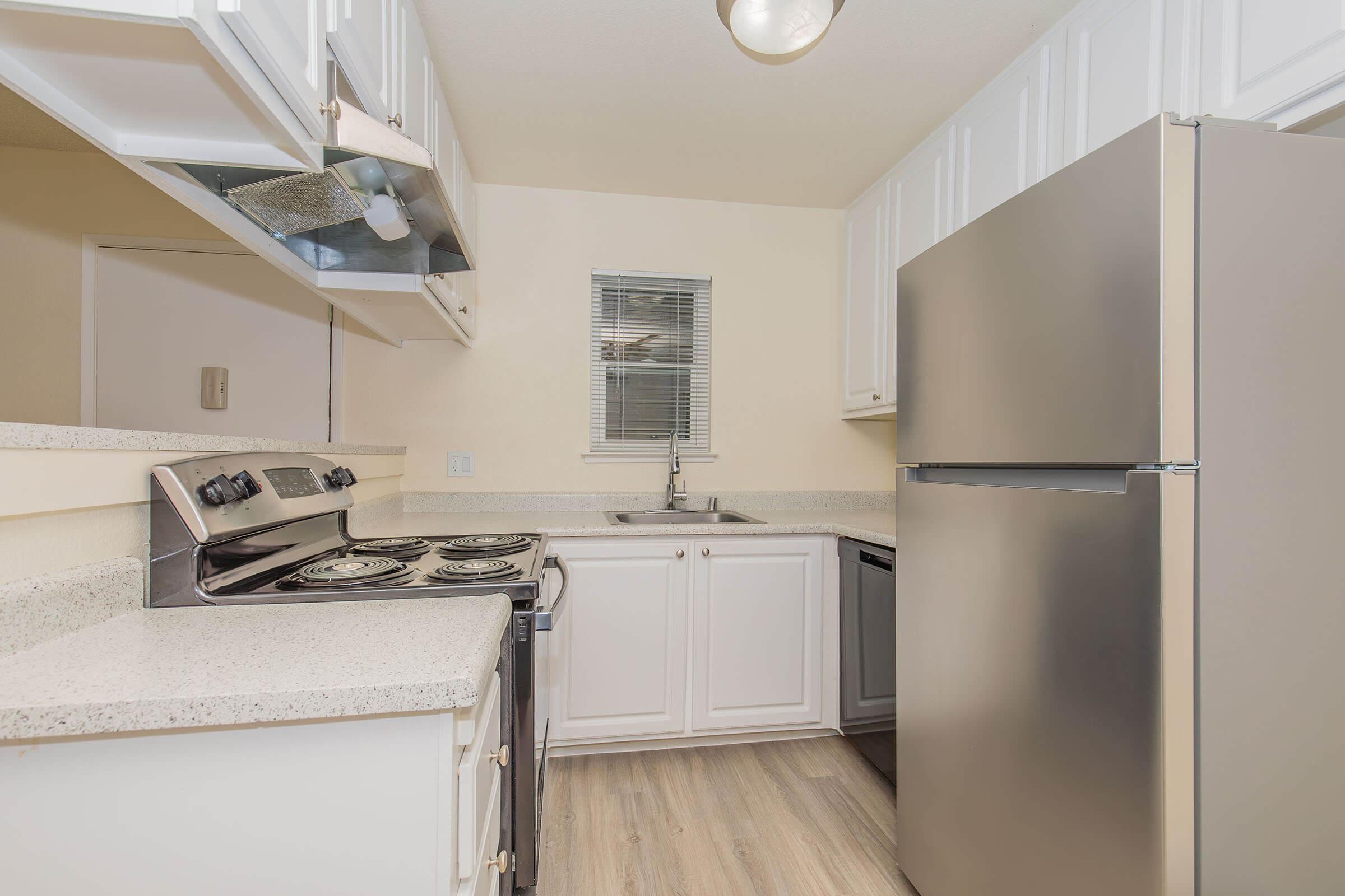 a kitchen with a sink and a refrigerator