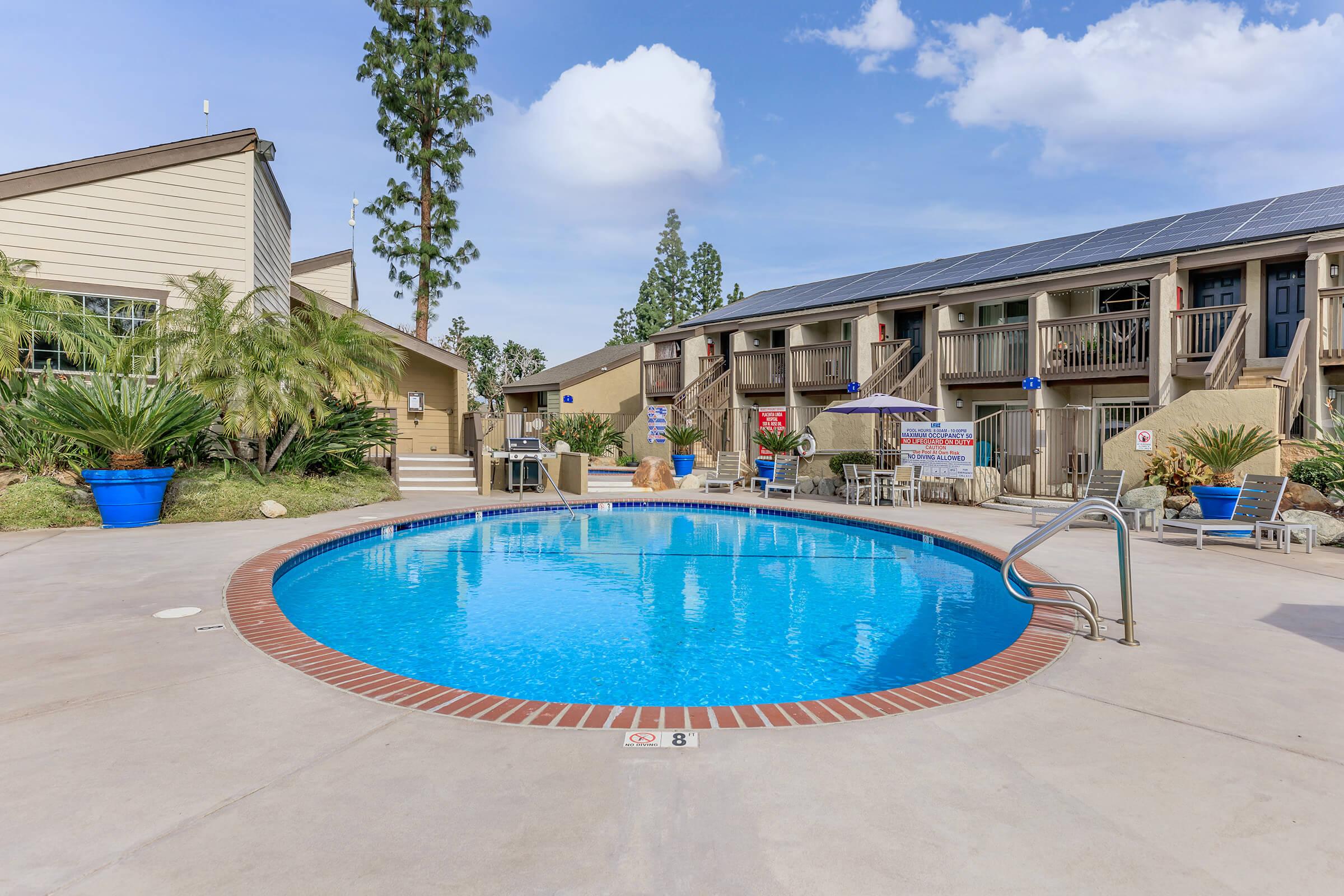 a blue pool of water in front of a building