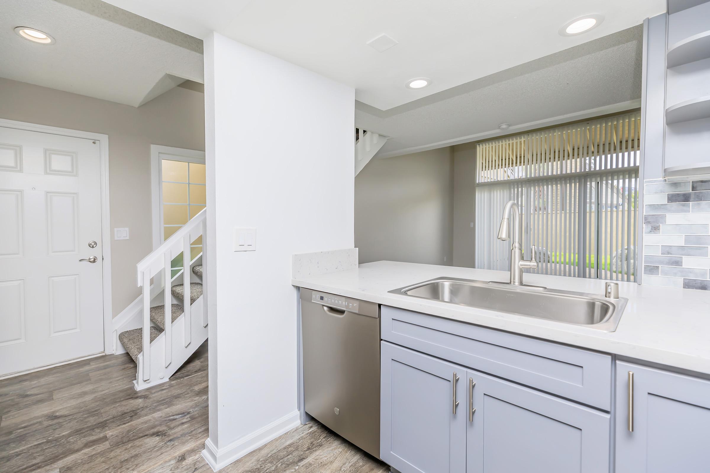 a kitchen with a sink and a window