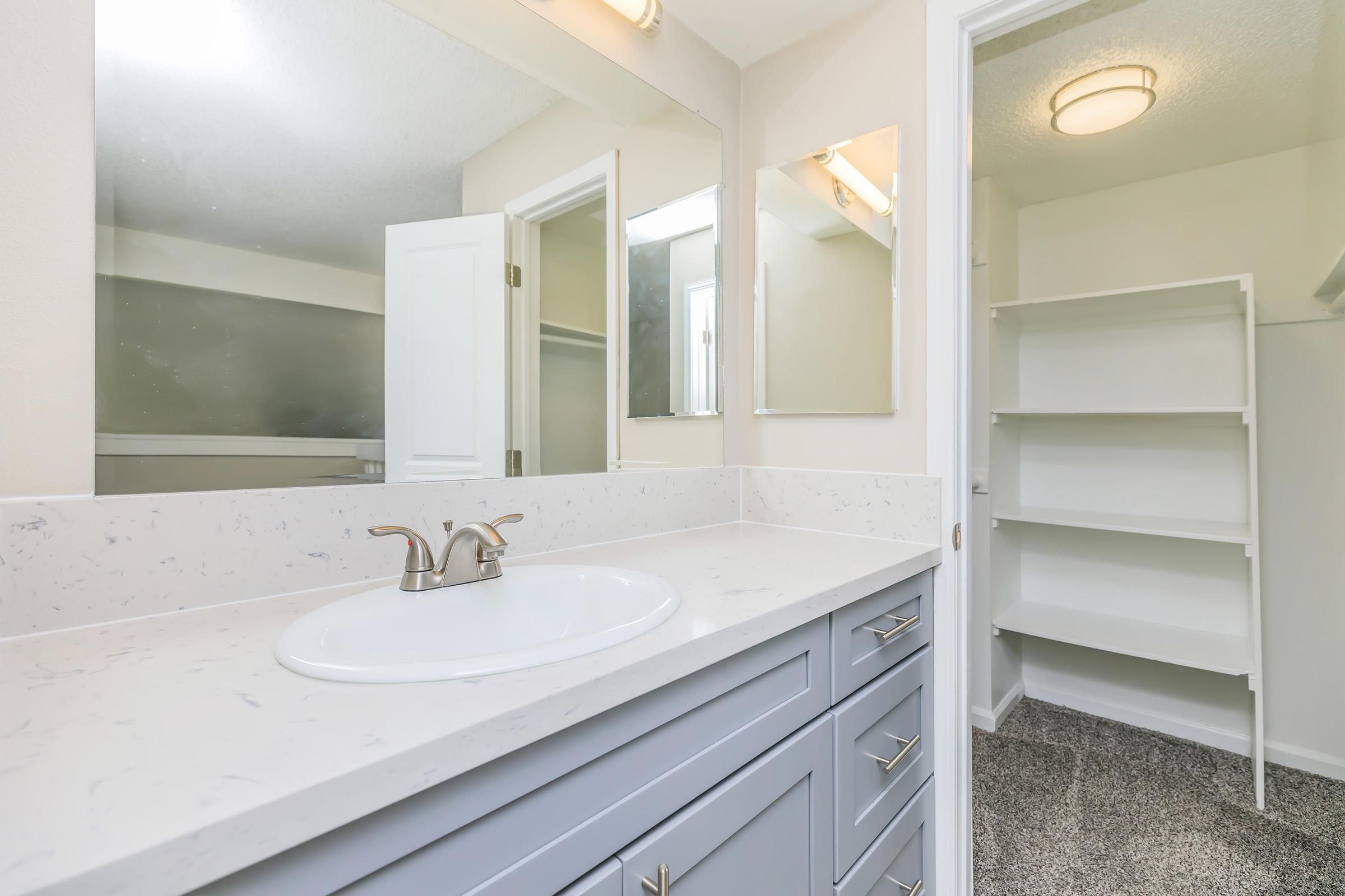 a kitchen with a sink and a mirror