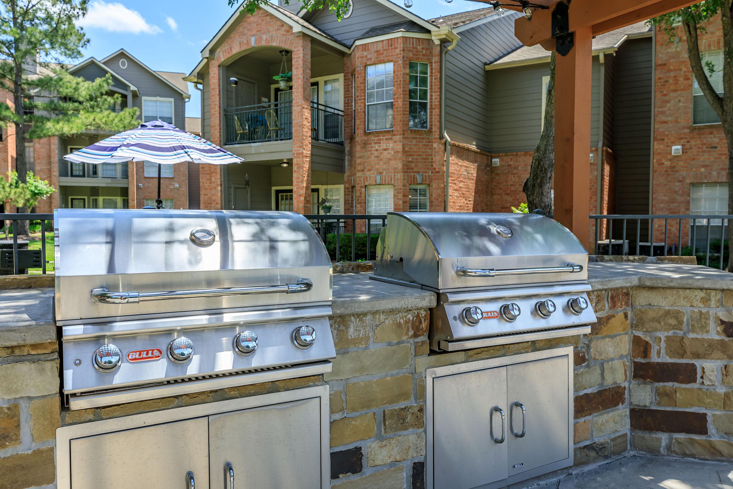 two stainless steel barbecues