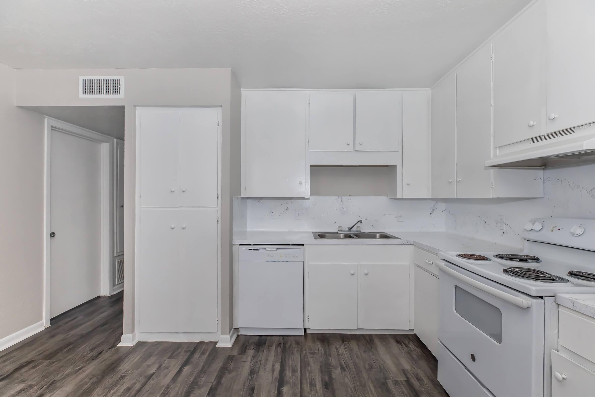 a kitchen with a stove and a refrigerator