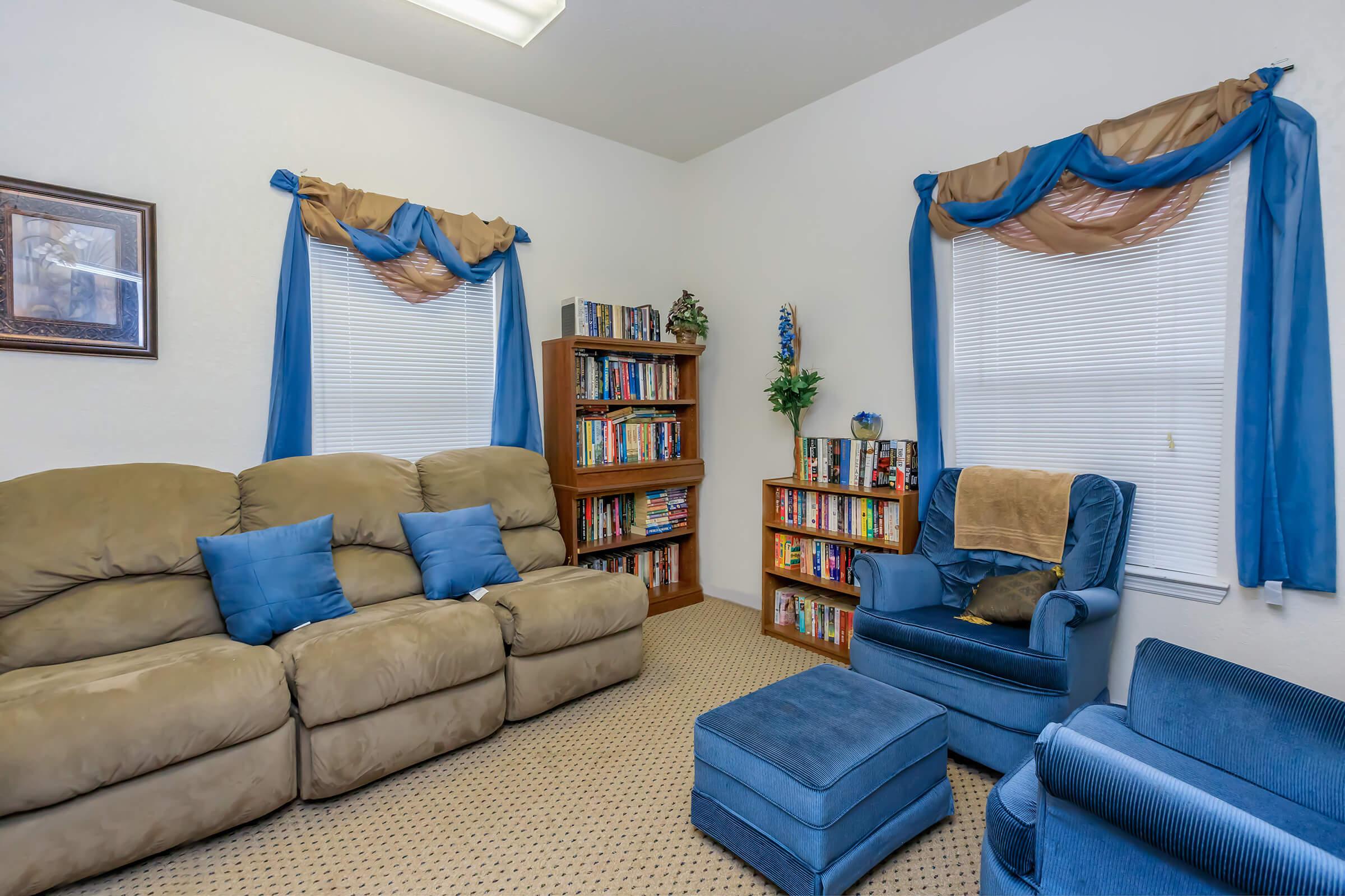 a living room filled with furniture and a blue chair