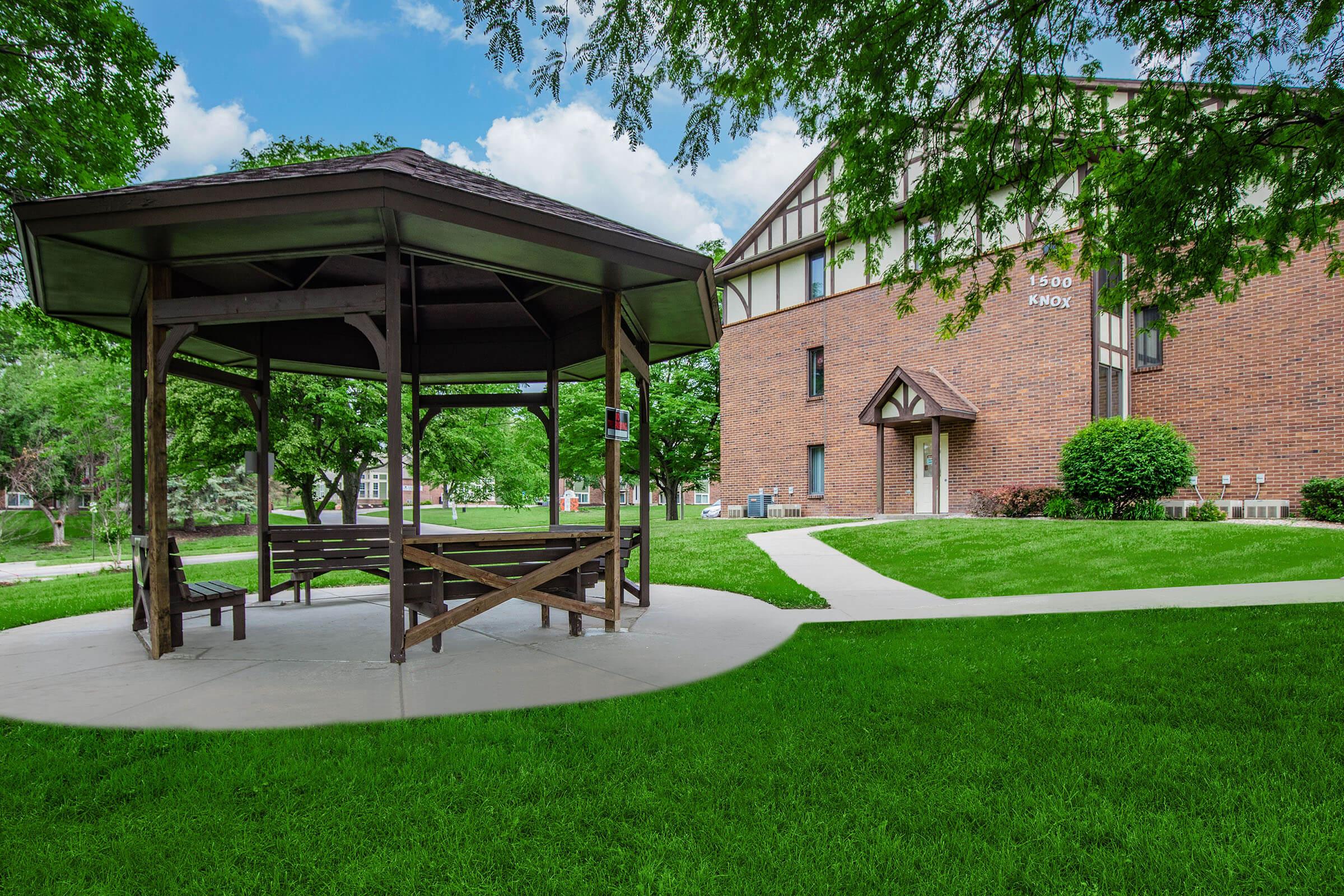 a couple of lawn chairs sitting on top of a lush green field