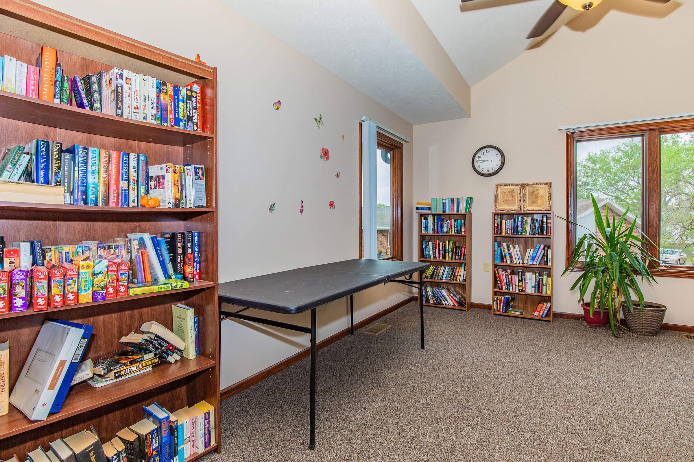 a living room filled with furniture and a book shelf