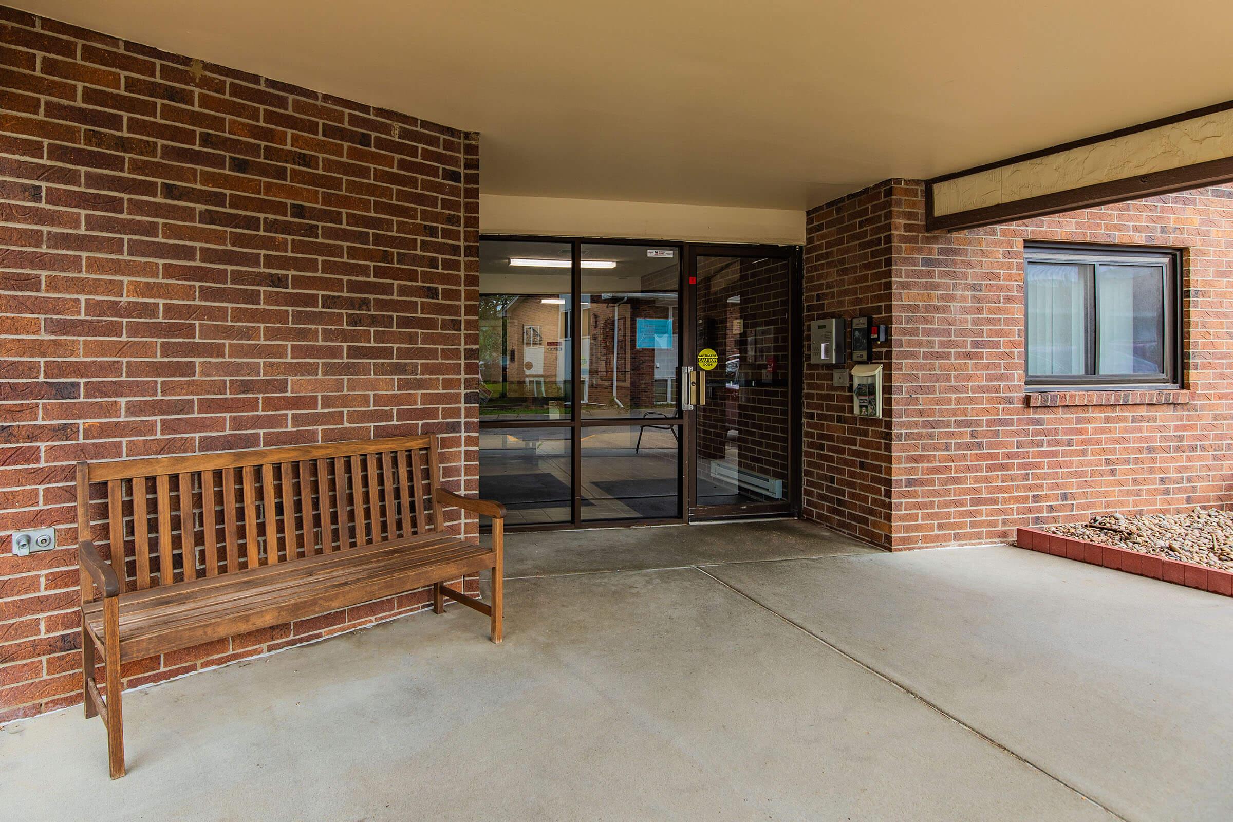 a chair sitting in front of a brick building