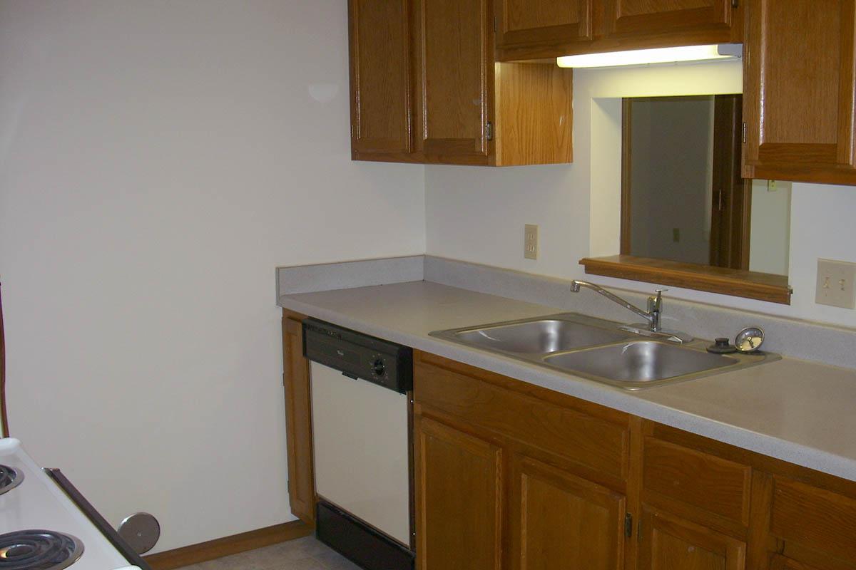 a kitchen with a sink and a mirror