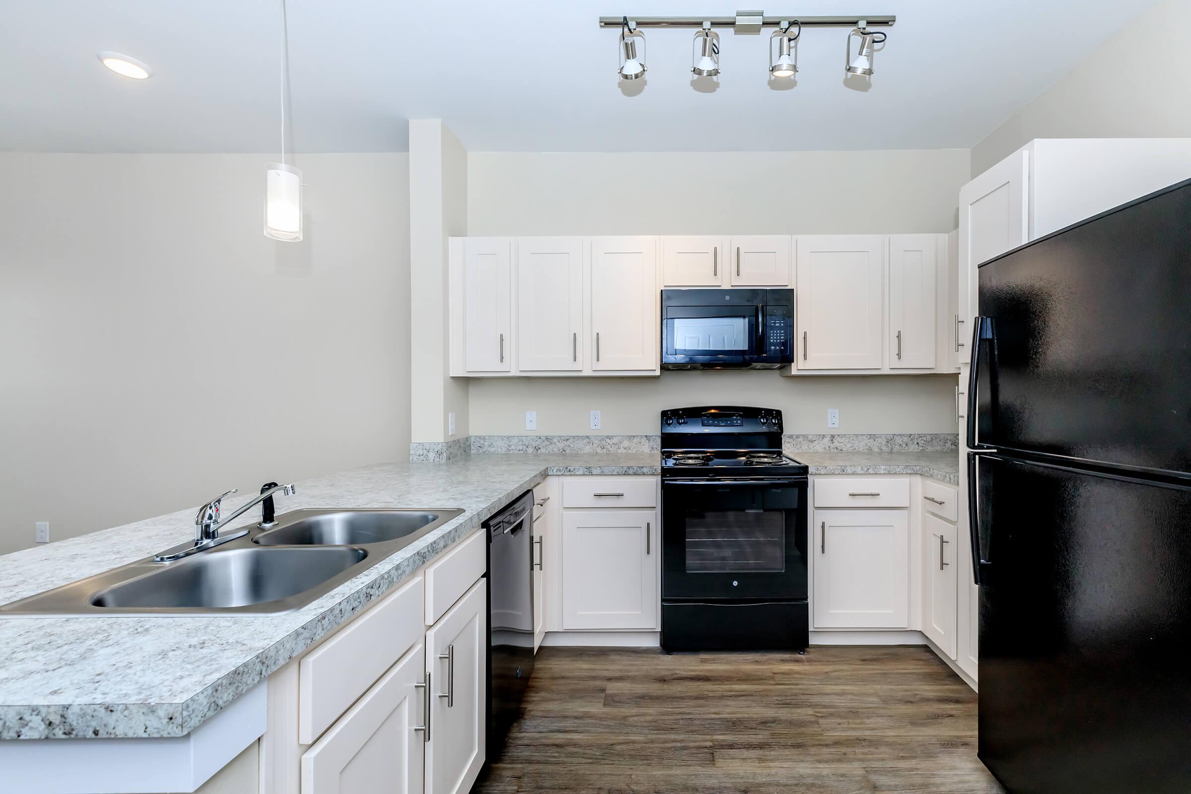 Apartments for Rent in Leander TX - Hills at Leander Spacious Kitchen with Plenty of Counterspace, Fully Equipped with Black Appliances, and Much More