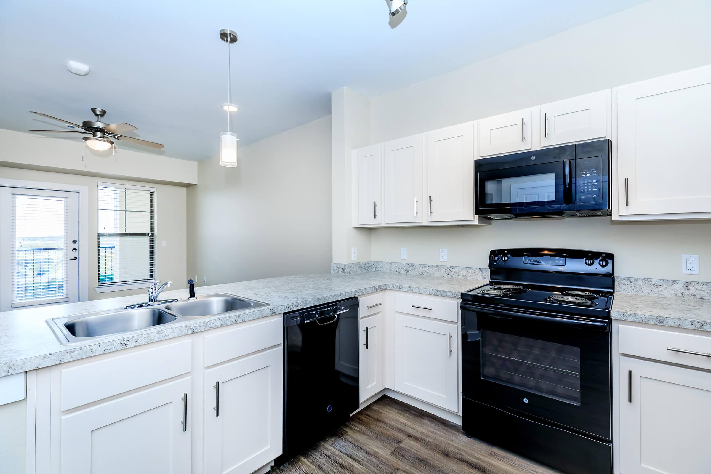 Apartments for Rent in Leander TX - Hills at Leander Spacious Kitchen with Plenty of Counterspace, Fully Equipped with Black Appliances, and Much More